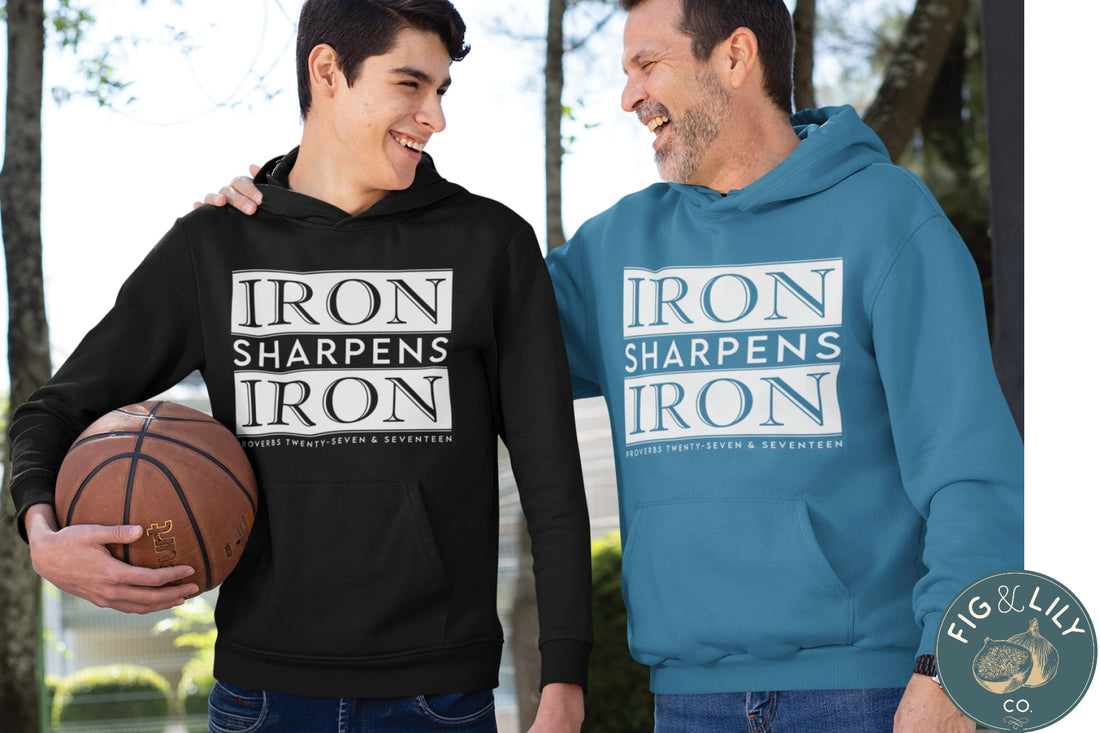 Iron Sharpens Iron Proverbs 27:17 Bible Verse Christian aesthetic faith-based hoodie with bold white design printed on cozy black unisex hoodie sweatshirt for men and women