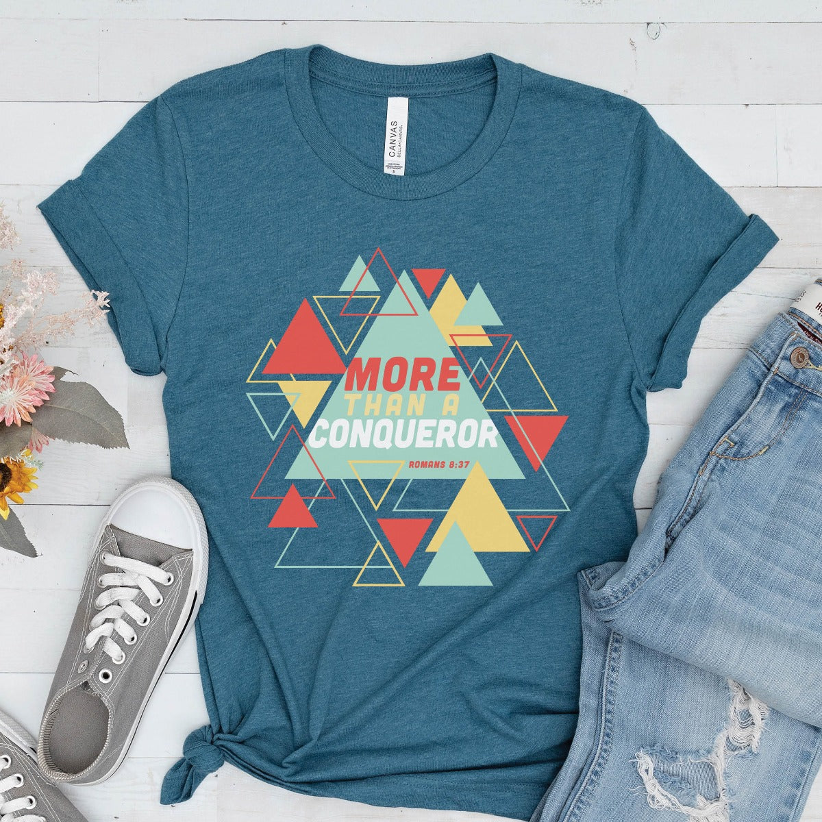 Heather Deep Teal "More Than A Conqueror" Romans 8:37 bible verse scripture unisex faith-based Christian Bella Canvas 3001 t-shirt, with bright and colorful geometric triangles pattern, made in the USA for Men and Women Jesus believers