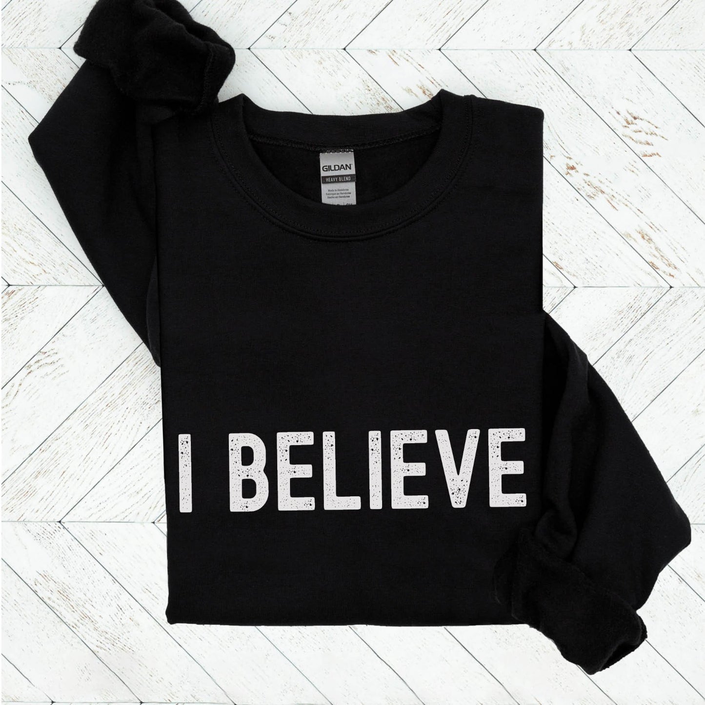 I Believe Christian aesthetic Jesus believer simple distressed white typography design printed on cozy black unisex crewneck sweatshirt, created for men & women