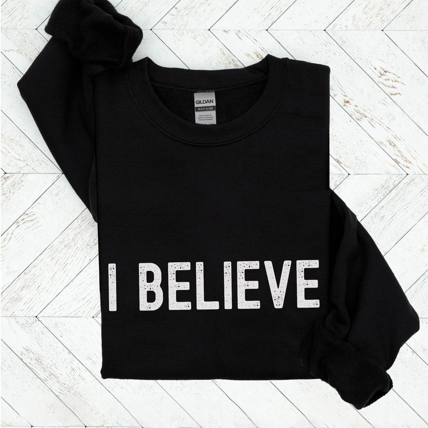 I Believe Christian aesthetic Jesus believer simple distressed white typography design printed on cozy black unisex crewneck sweatshirt, created for men & women