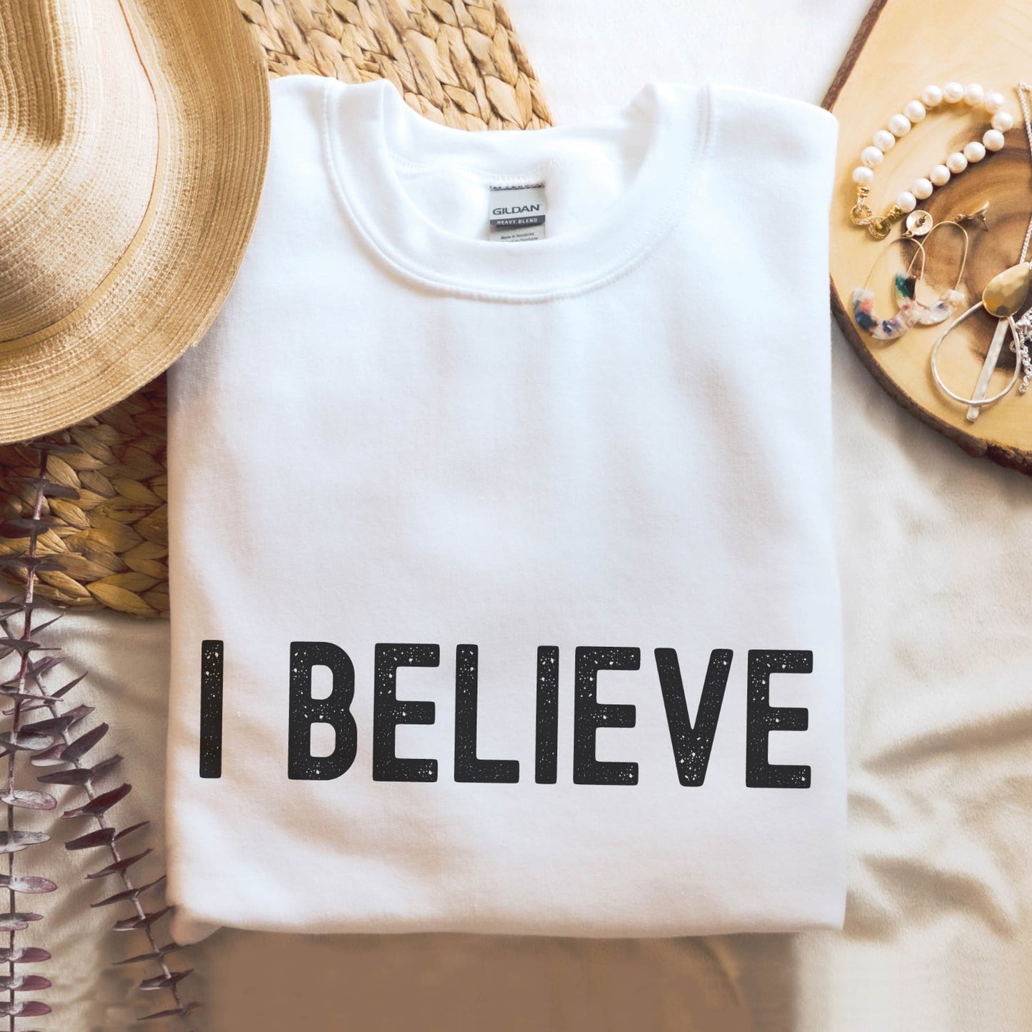 I Believe Christian aesthetic Jesus believer matte black simple distressed typography design printed on cozy white unisex crewneck sweatshirt, created for men & women
