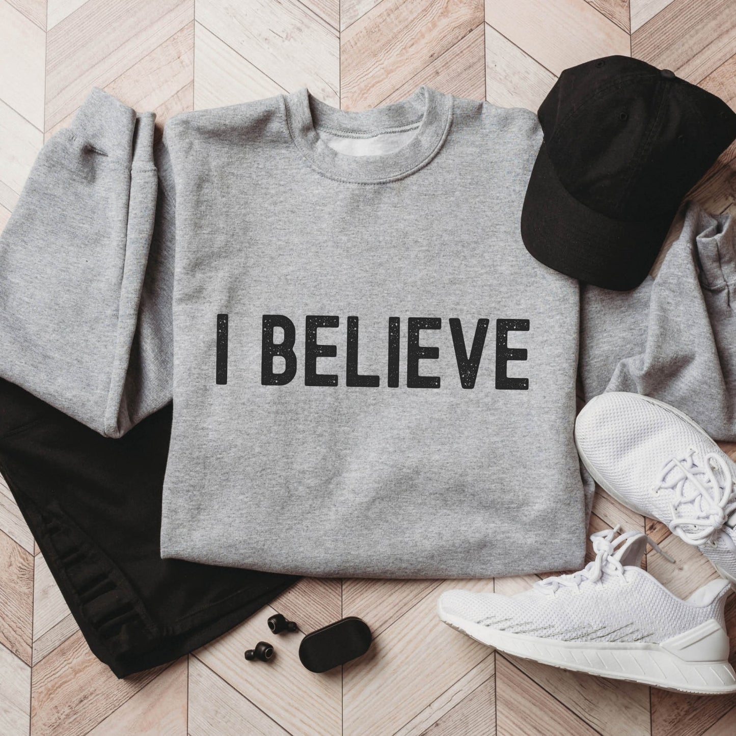 I Believe Christian aesthetic Jesus believer matte black simple distressed typography design printed on cozy heather sport gray unisex crewneck sweatshirt, created for men & women