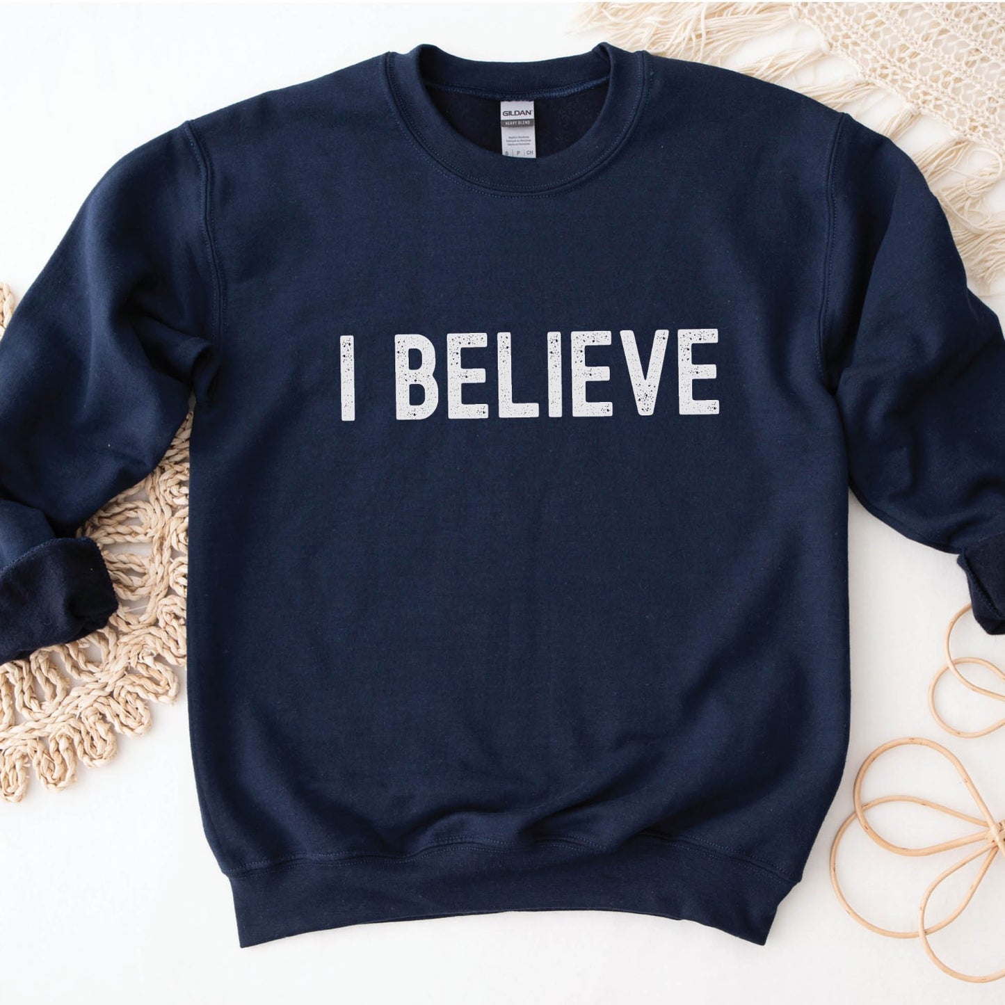 I Believe Christian aesthetic Jesus believer simple distressed white typography design printed on cozy navy blue unisex crewneck sweatshirt, created for men & women