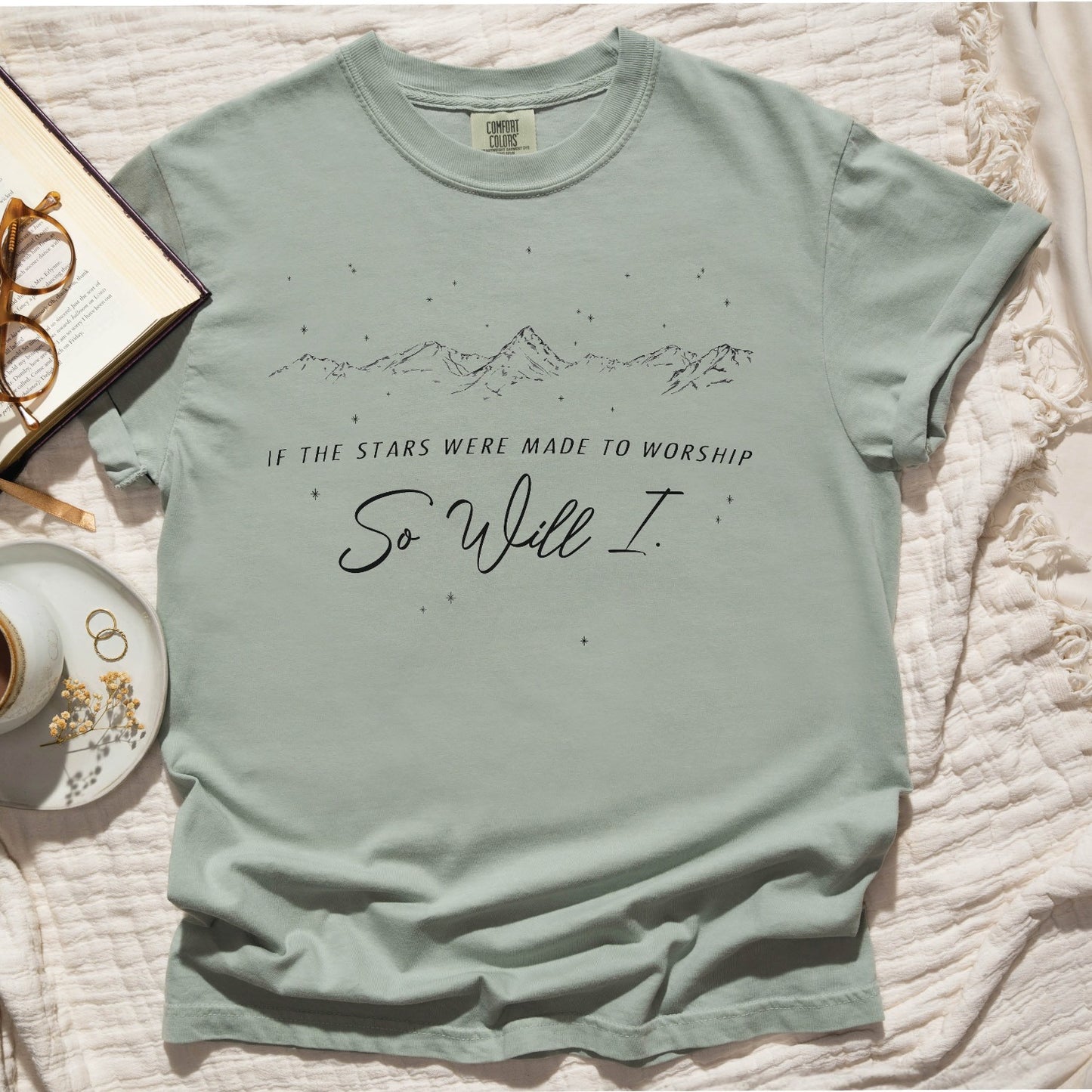 Bay sage green color garment-dyed unisex Comfort Colors 1717 t-shirt with black mountain range and starry sky that says this faith-based bible verse quote, "If the Stars Were Made to Worship So Will I", created for Christian men and women Kingdom believers