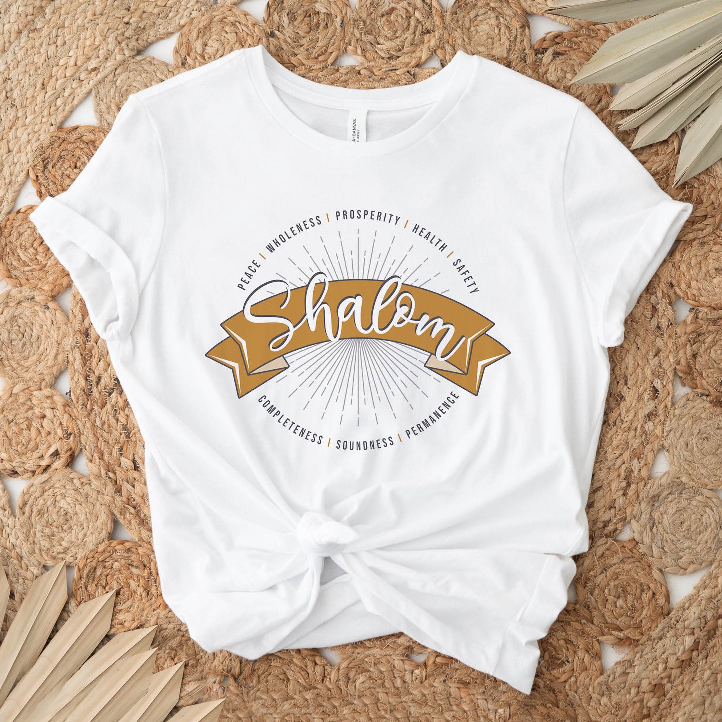 Soft white faith-based Christian women's unisex t-shirt with a gold banner and sunburst design that says the Hebrew meaning of the word "SHALOM" - Peace, Completeness, Prosperity, Health, Safety, Wholeness, Soundness, and Permanence definition, makes a great mother's day gift for mom!