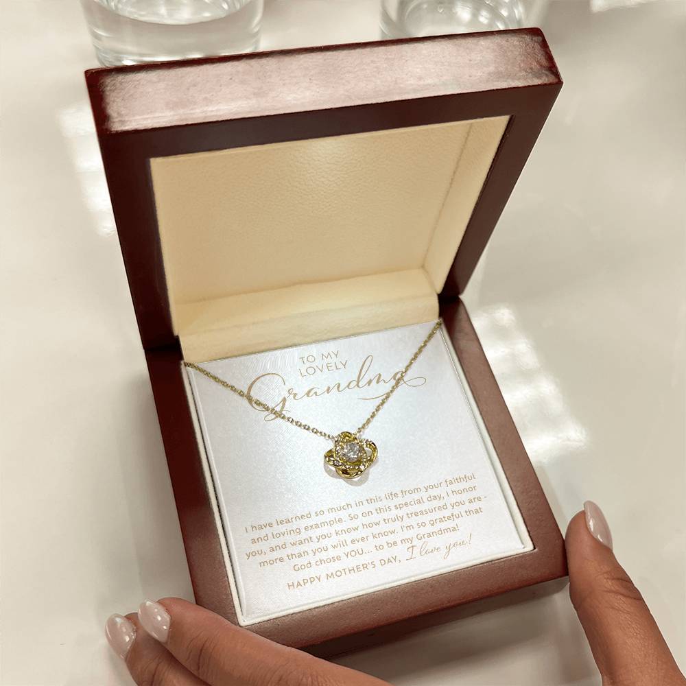 To my Lovely Grandma 18k yellow gold sparkling cubic zirconia Love Knot necklace Happy Mother's Day Gift to Grandmother with heart warming message card nestled inside luxury LED light mahogany jewelry gift box