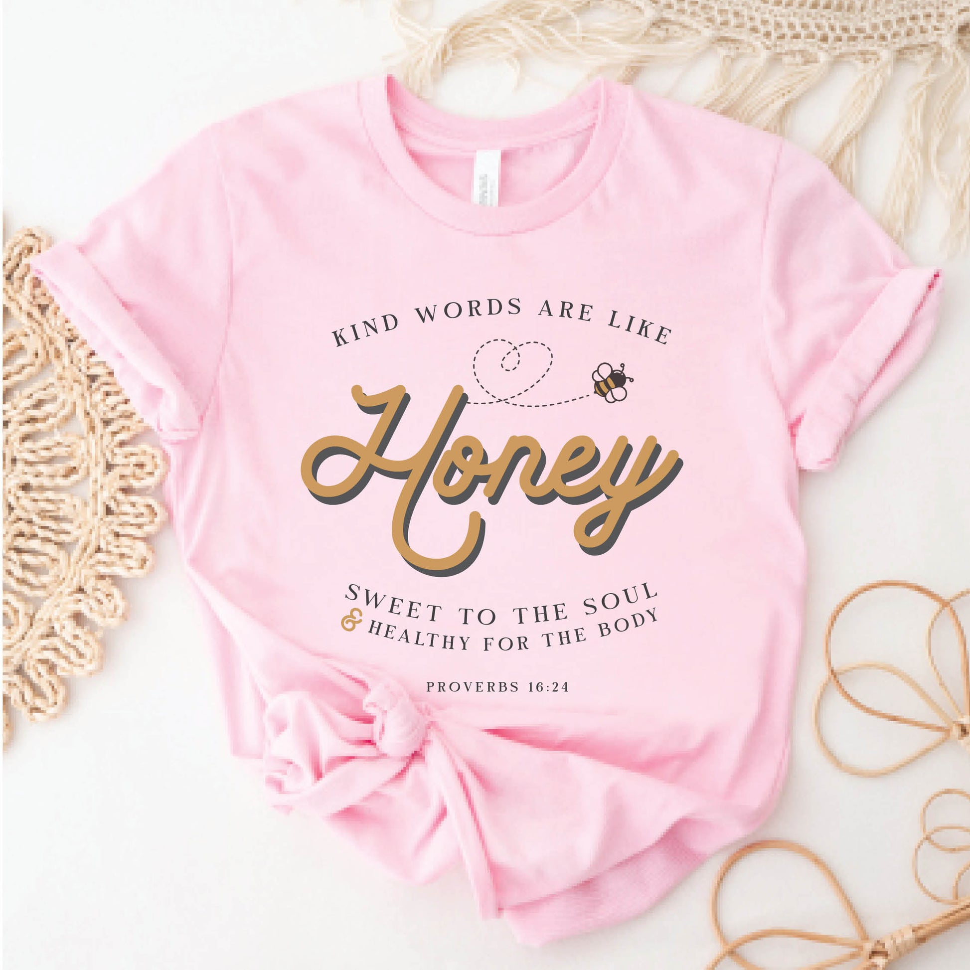 Pink & gold Christian aesthetic unisex faith-based kindness bee t-shirt for women with Proverbs 16:24 bible verse quote that says, "Kind Words Are Like Honey, Sweet To the Soul, and Healthy For the Body"