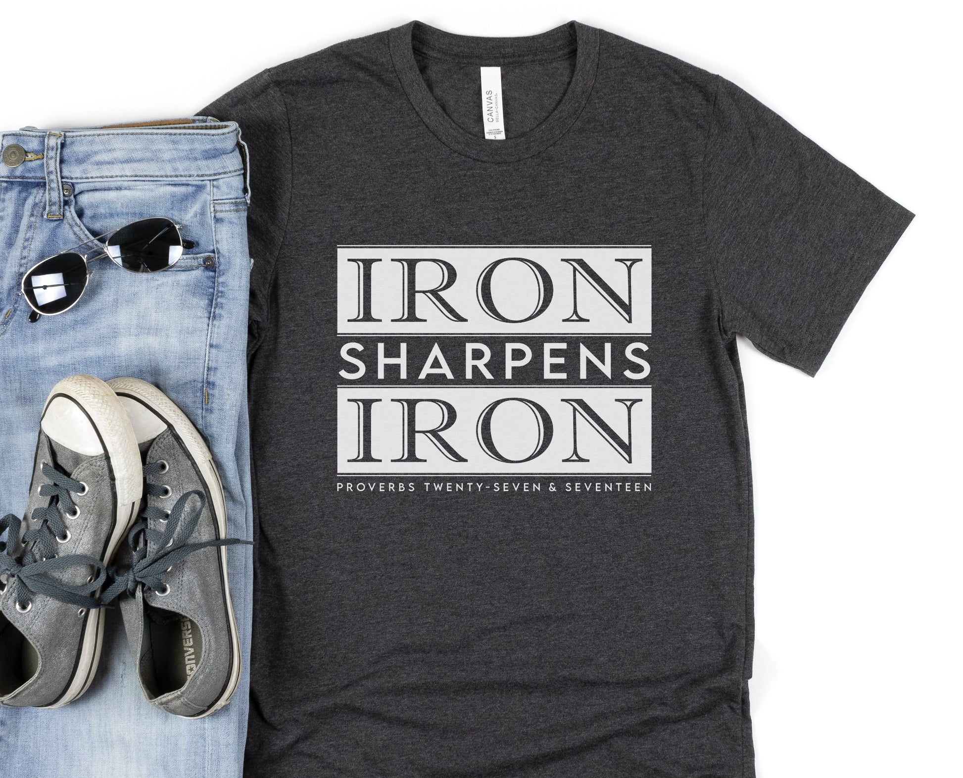 Iron Sharpens Iron Proverbs 27:17 Christian aesthetic block style design printed in white on soft heather dark gray unisex t-shirt for men's groups