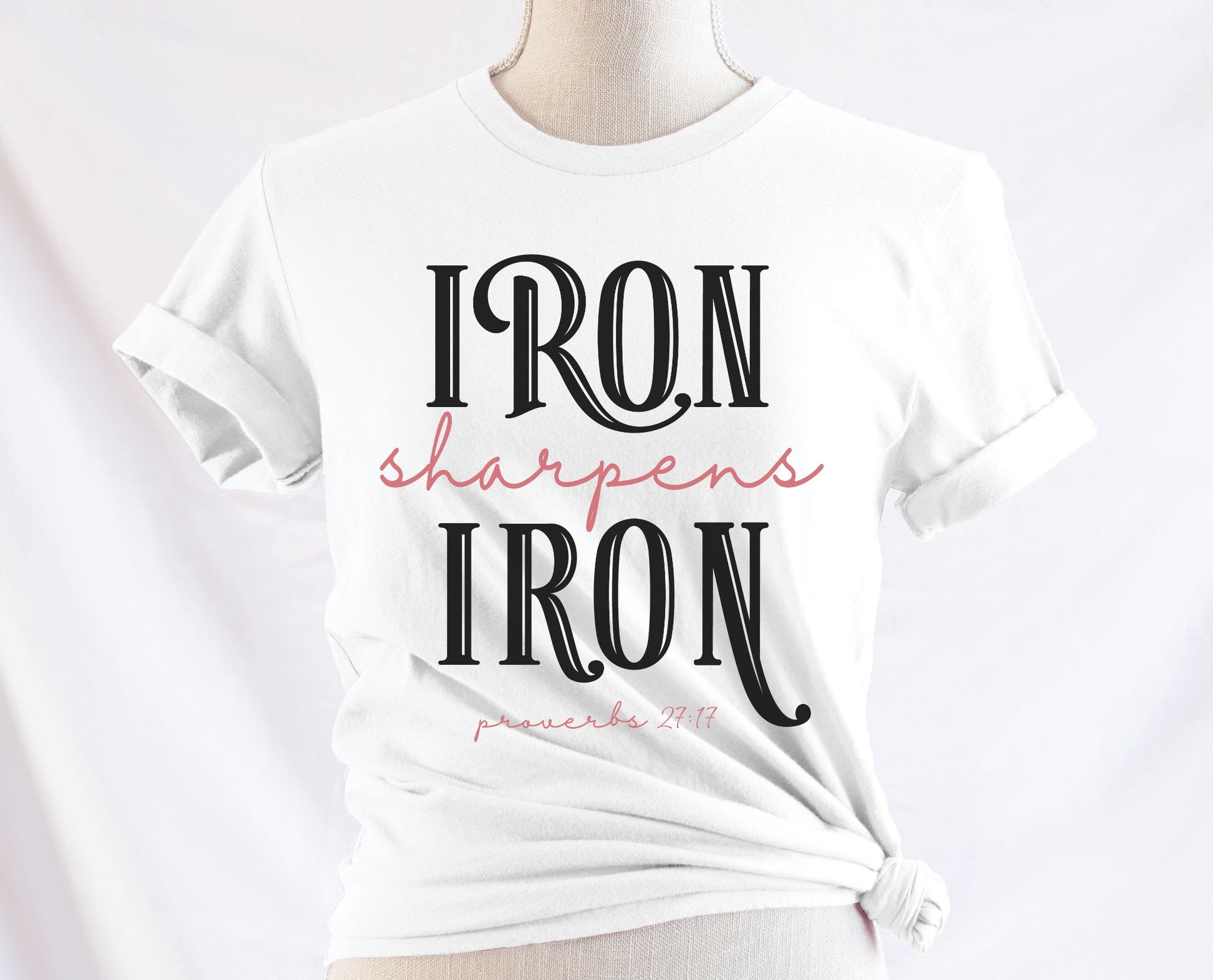 Iron Sharpens Iron Proverbs 27:17 Christian aesthetic design printed in black and mauve on ladies soft white unisex t-shirt for women's groups