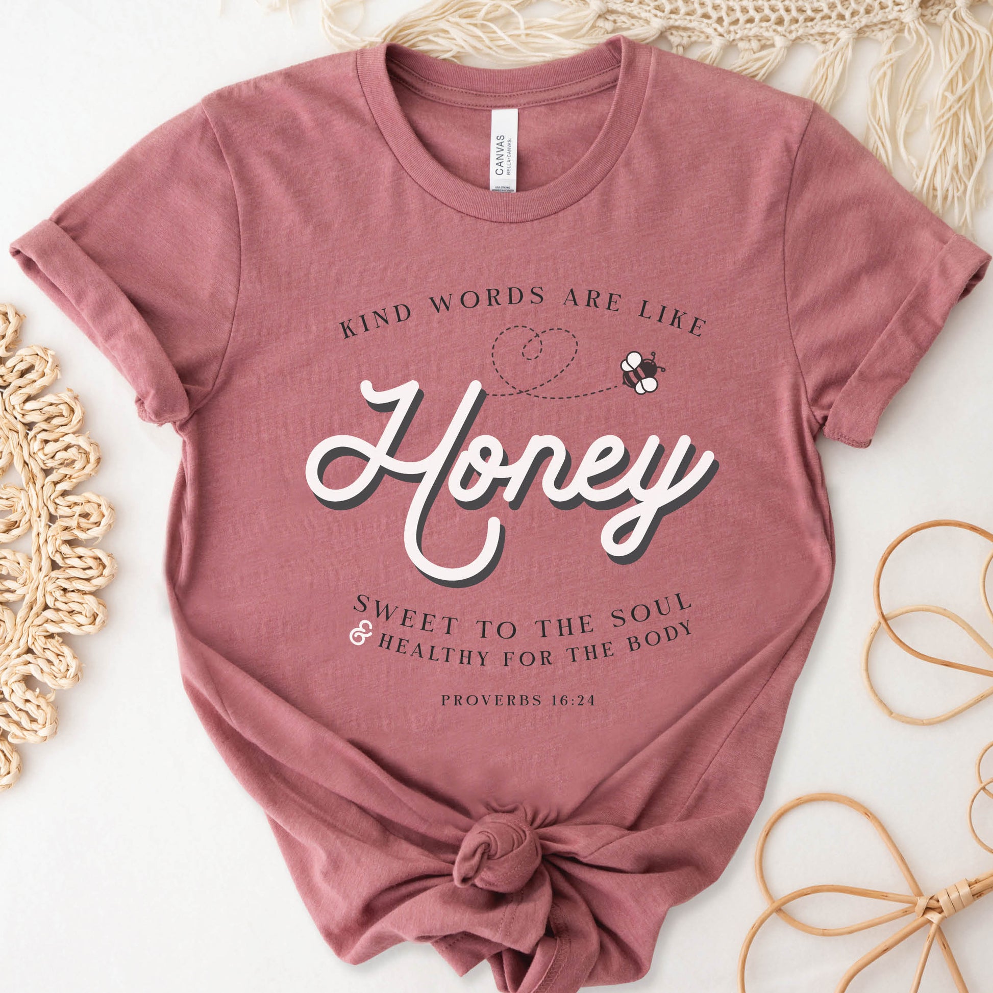 Mauve & gold Christian aesthetic unisex faith-based kindness bee t-shirt for women with Proverbs 16:24 bible verse quote that says, "Kind Words Are Like Honey, Sweet To the Soul, and Healthy For the Body"
