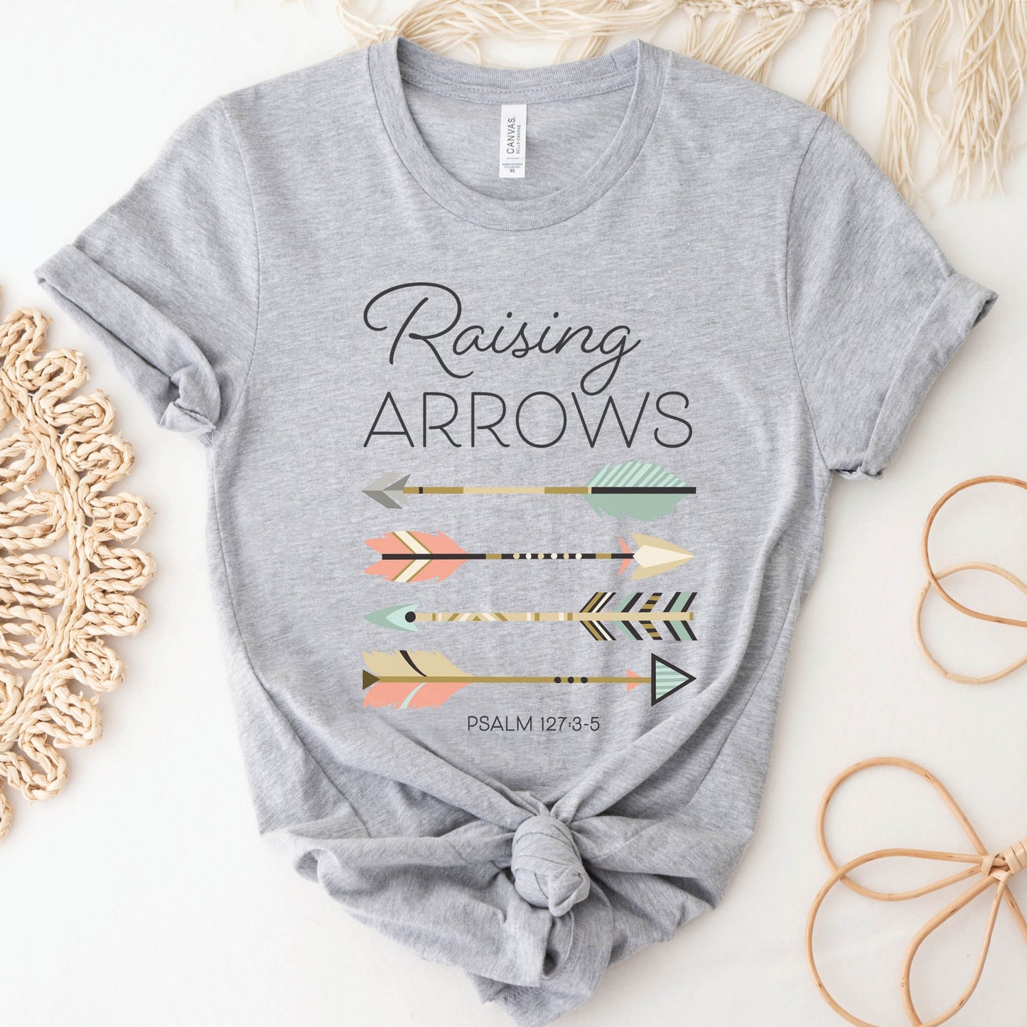 Boho Raising Arrows Psalm 127 Quiver Full Christian aesthetic faith-based design printed in peach, cream, light teal, gold dark gray on soft athletic heather gray unisex t-shirt for women and Moms