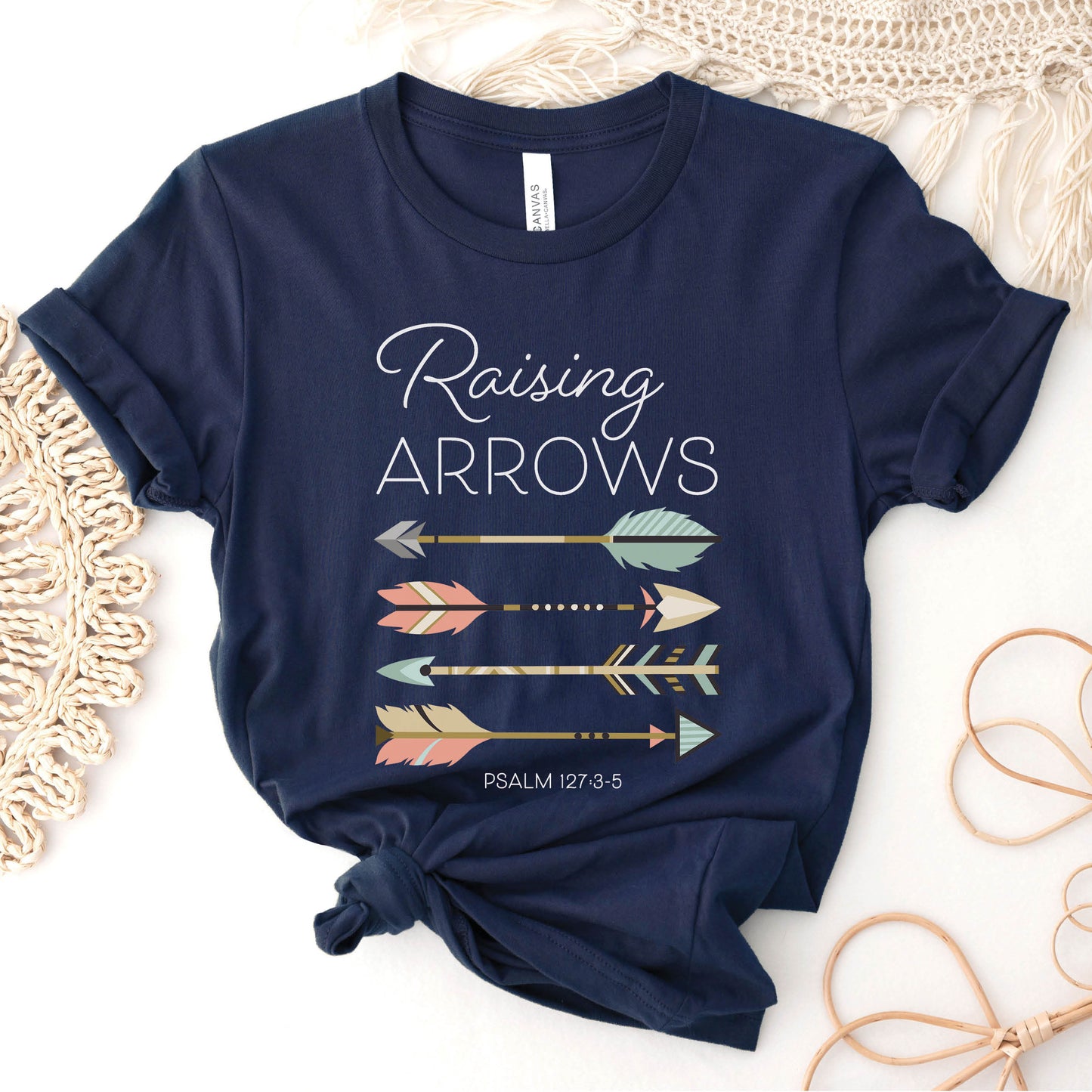 Boho Raising Arrows Psalm 127 Quiver Full Christian aesthetic faith-based design printed in peach, cream, light teal, gold, and white on soft navy blue unisex t-shirt for women and Moms