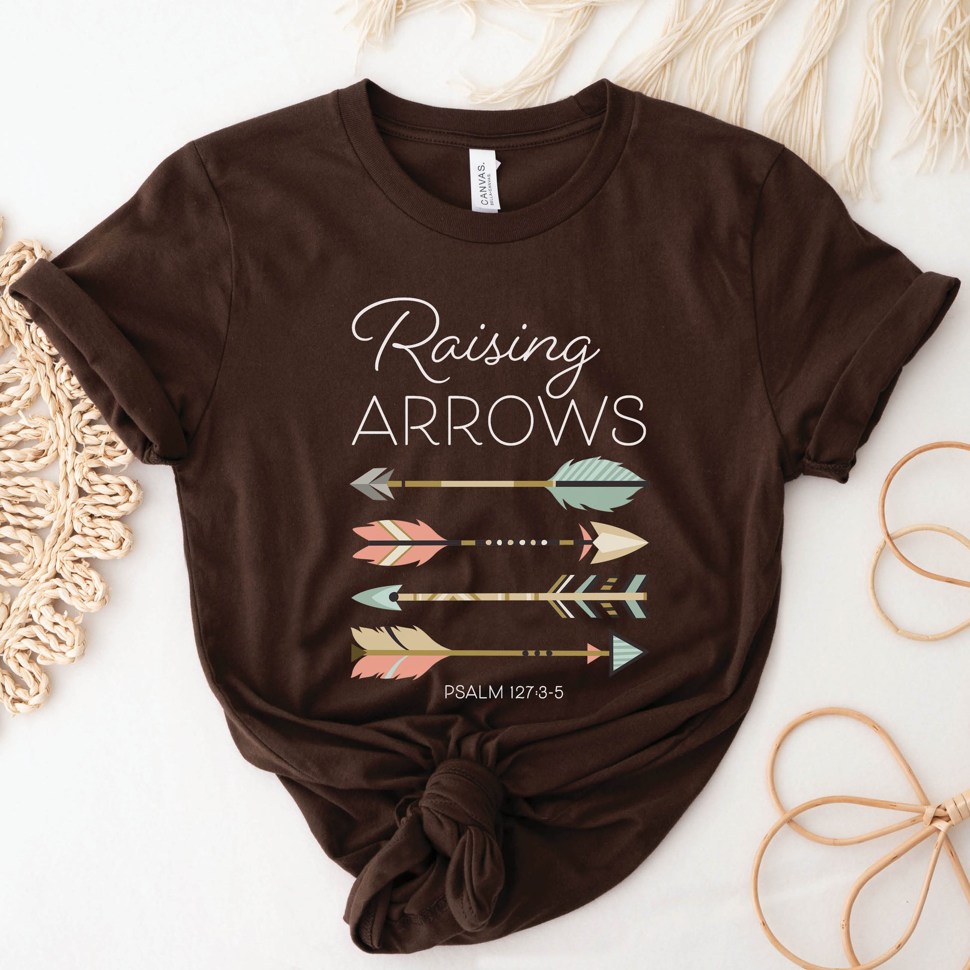 Boho Raising Arrows Psalm 127 Quiver Full Christian aesthetic faith-based design printed in peach, cream, light teal, gold, and white on soft mocha brown unisex t-shirt for women and Moms