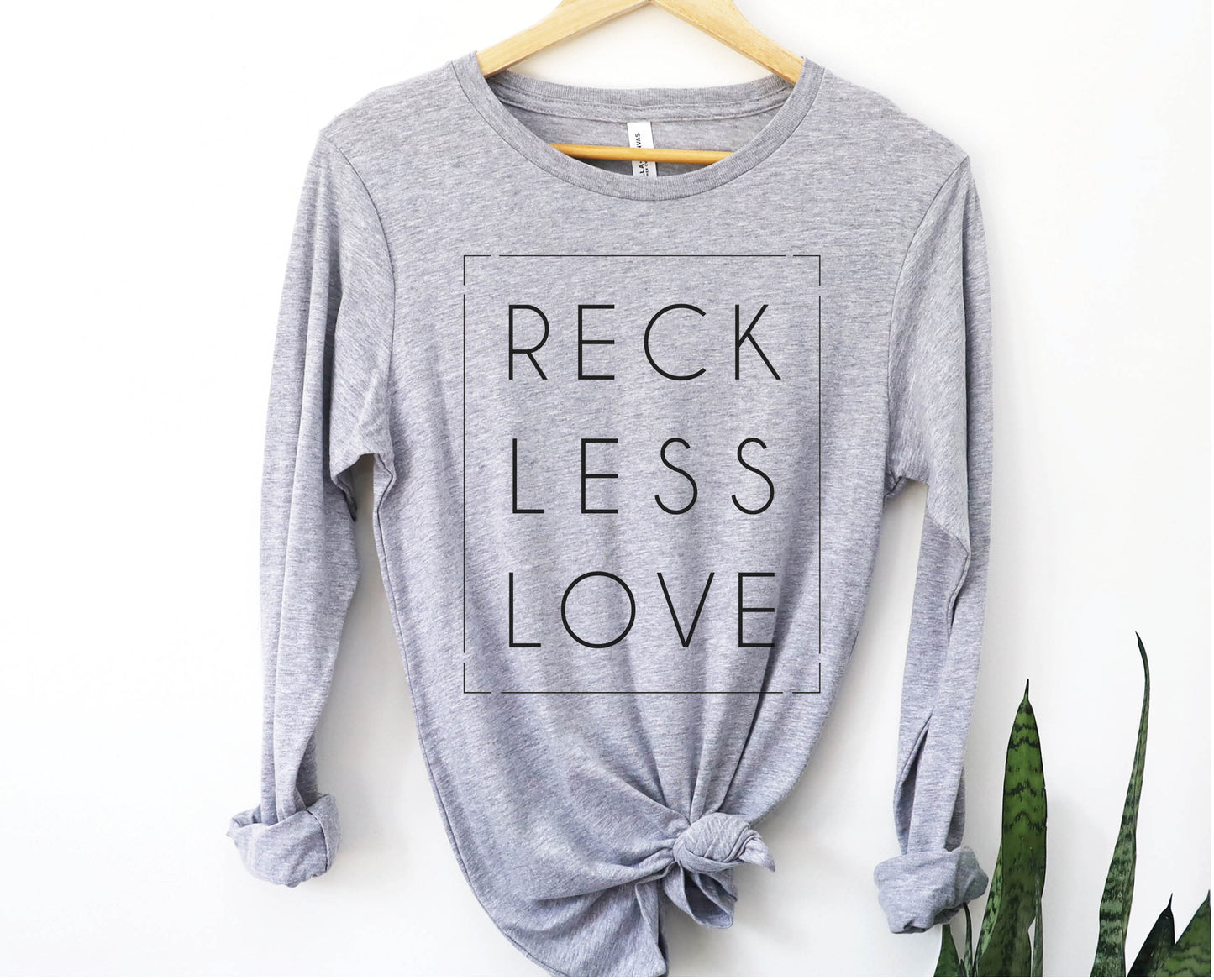 Rectangle Reckless Love Christian aesthetic worship design printed in black on cozy white unisex long sleeve tee shirt for men and women