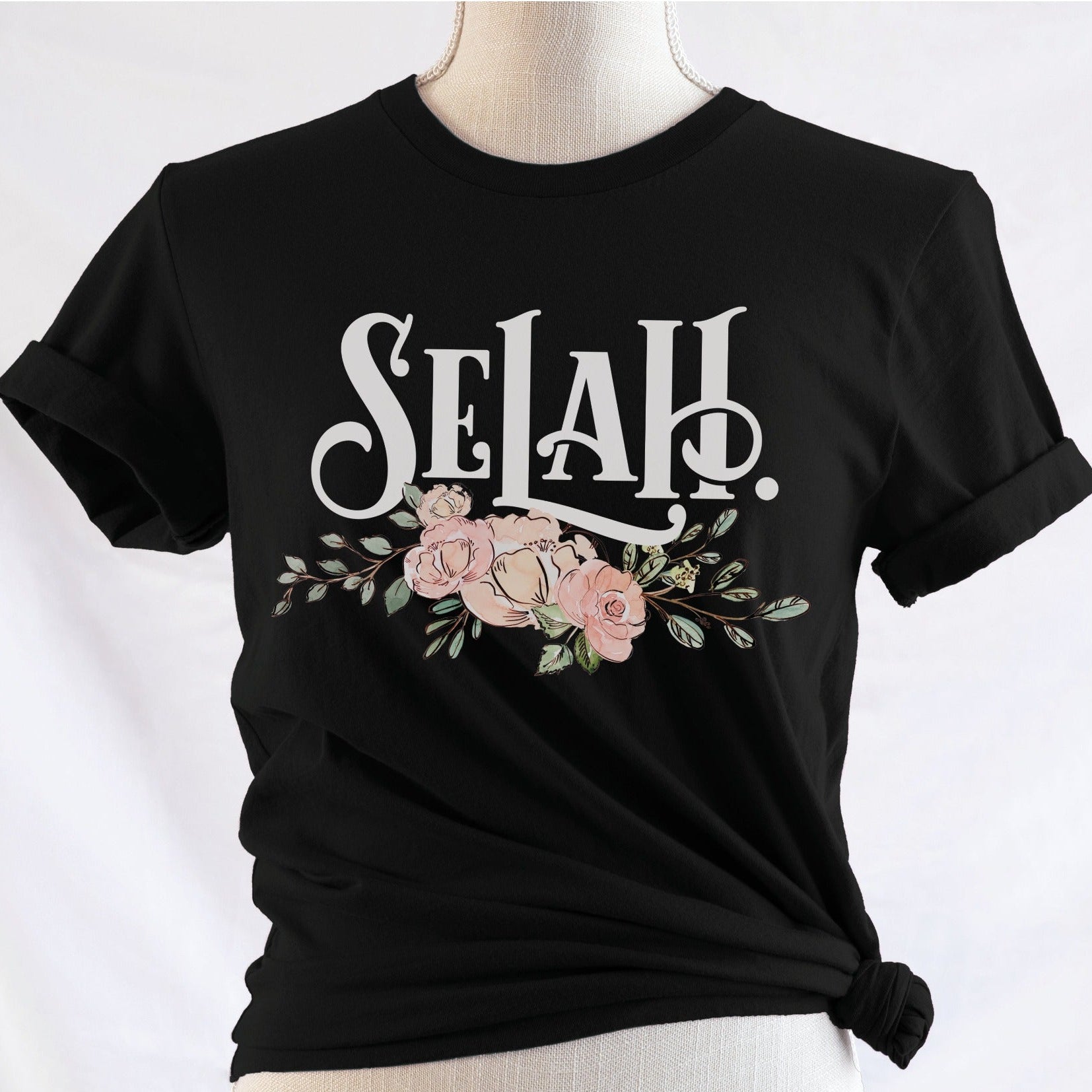 Selah Psalm bible verse watercolor floral Christian aesthetic design printed in white peach blush pink on soft black t-shirt for women