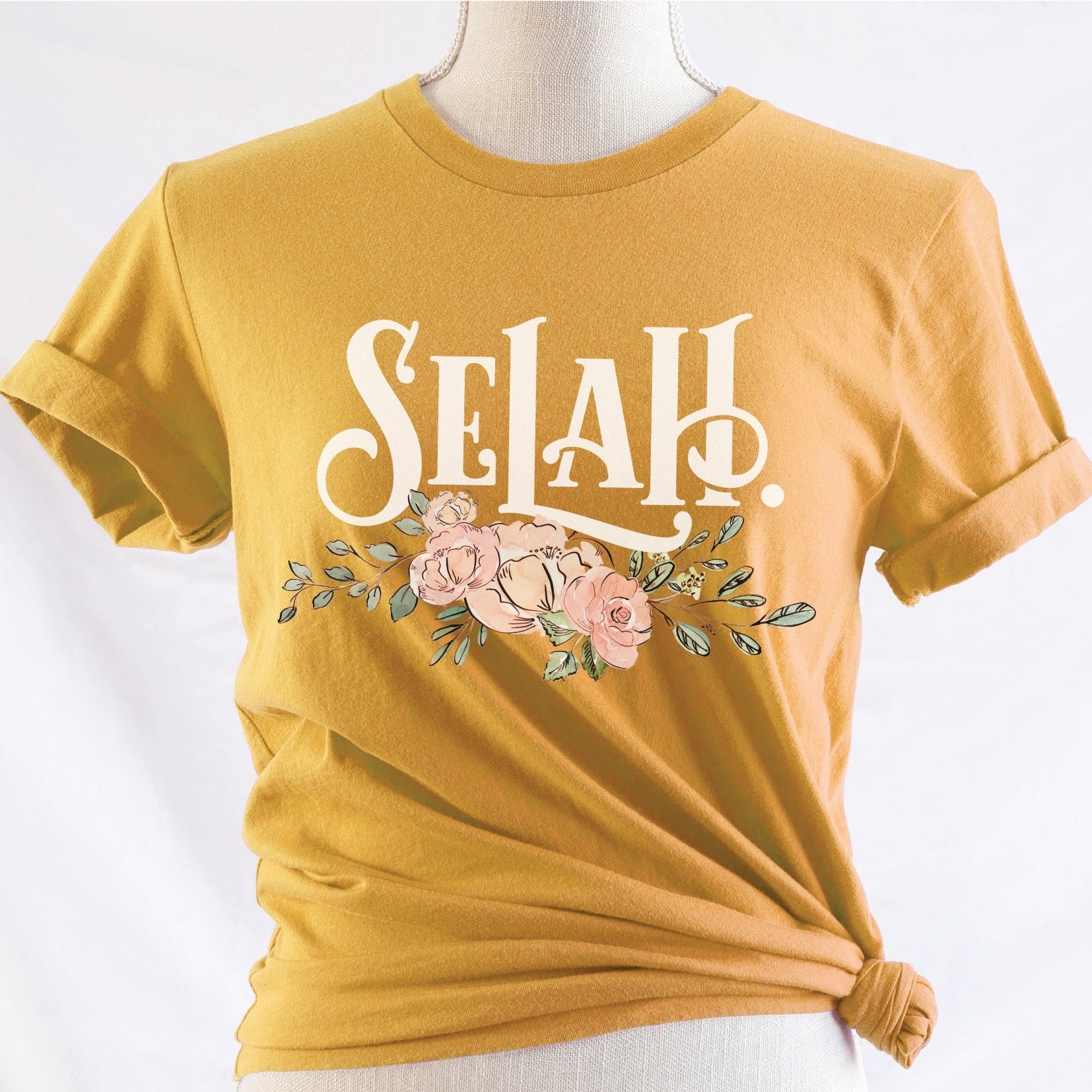 Selah Psalm bible verse watercolor floral Christian aesthetic design printed in white peach blush pink on soft mustard yellow t-shirt for women