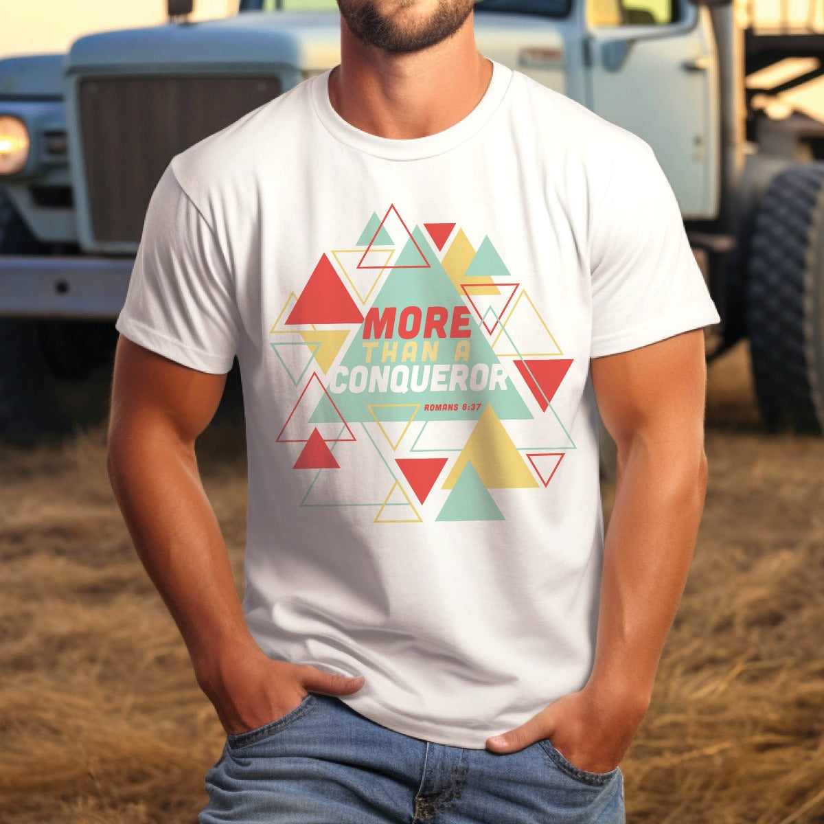 Strong man wearing a white "More Than A Conqueror" Romans 8:37 bible verse scripture unisex faith-based Christian Bella Canvas 3001 t-shirt, with bright and colorful geometric triangles pattern, made in the USA for Men and Women Jesus believers
