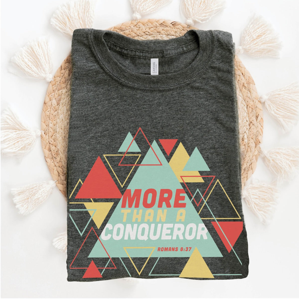 Heather Dark Gray "More Than A Conqueror" Romans 8:37 bible verse scripture unisex faith-based Christian Bella Canvas 3001 t-shirt, with bright and colorful geometric triangles pattern, made in the USA for Men and Women Jesus believers