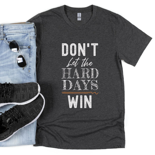 Faith-based "Don't Let the Hard Days Win" Christian men's soft heather dark gray unisex t-shirt with bold typography design printed in white, great gift for the encourager in your life