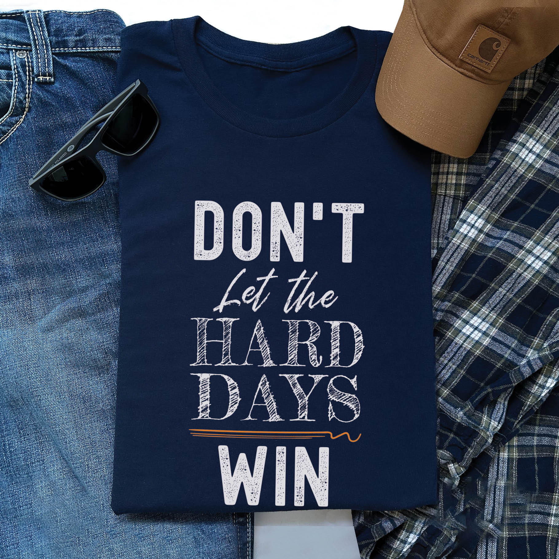 Navy blue men's unisex Christian t-shirt with a bold typography design that says, "Don't Let The Hard Days Win" printed on the front in white and orange