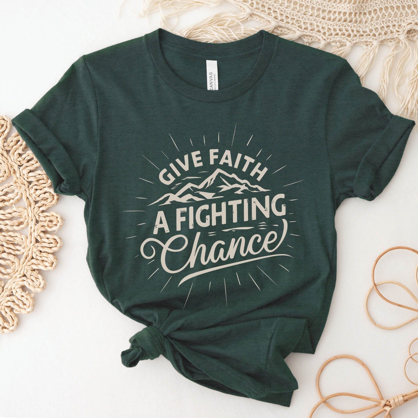 Heather Forest Dark Green Unisex Tee with Christian Bible verse quote that says, "Give Faith A Fighting Chance" with retro sunburst and mountain graphics, t-shirt designed for faith-based men and women
