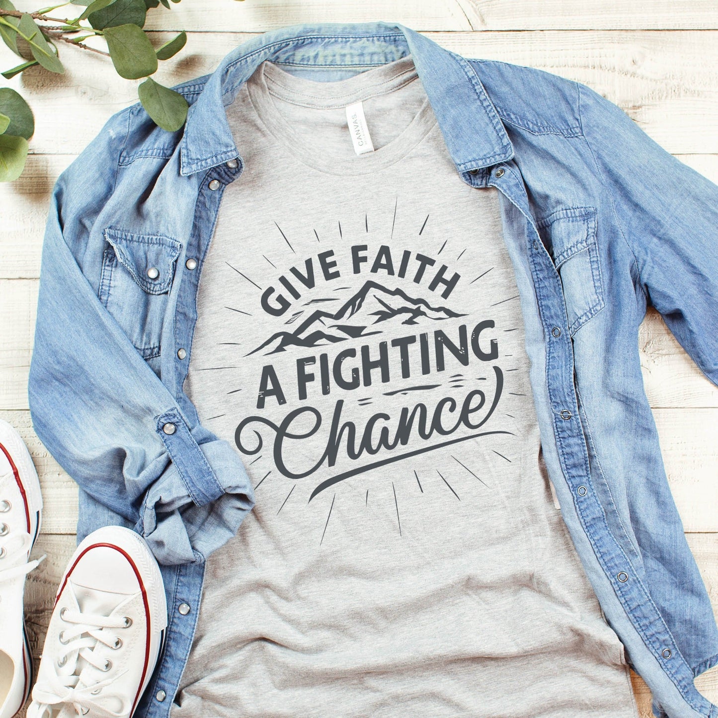 Heather Gray Unisex Tee with Christian Bible verse quote that says, "Give Faith A Fighting Chance" in charcoal gray with retro sunburst and mountain graphics, t-shirt designed for faith-based men and women