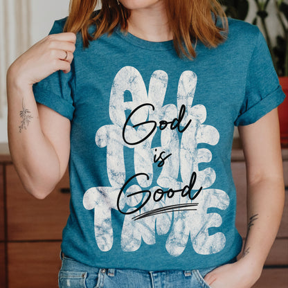 Young woman wearing a Christian faith-based unisex heather deep teal t-shirt with inspirational quote 'God is Good All The Time' in modern trendy font – religious apparel for men and women