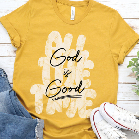 Christian faith-based unisex mustard yellow t-shirt with inspirational quote 'God is Good All The Time' in modern trendy font – religious apparel for men and women