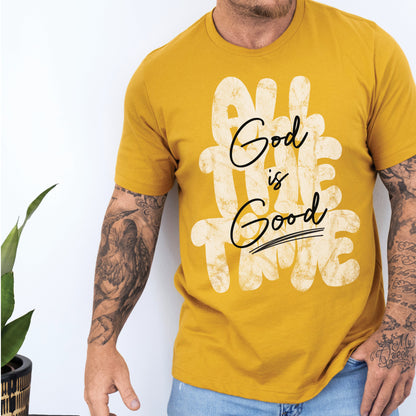 Man wearing a Christian faith-based unisex mustard yellow t-shirt with inspirational quote 'God is Good All The Time' in modern trendy font – religious apparel for men and women