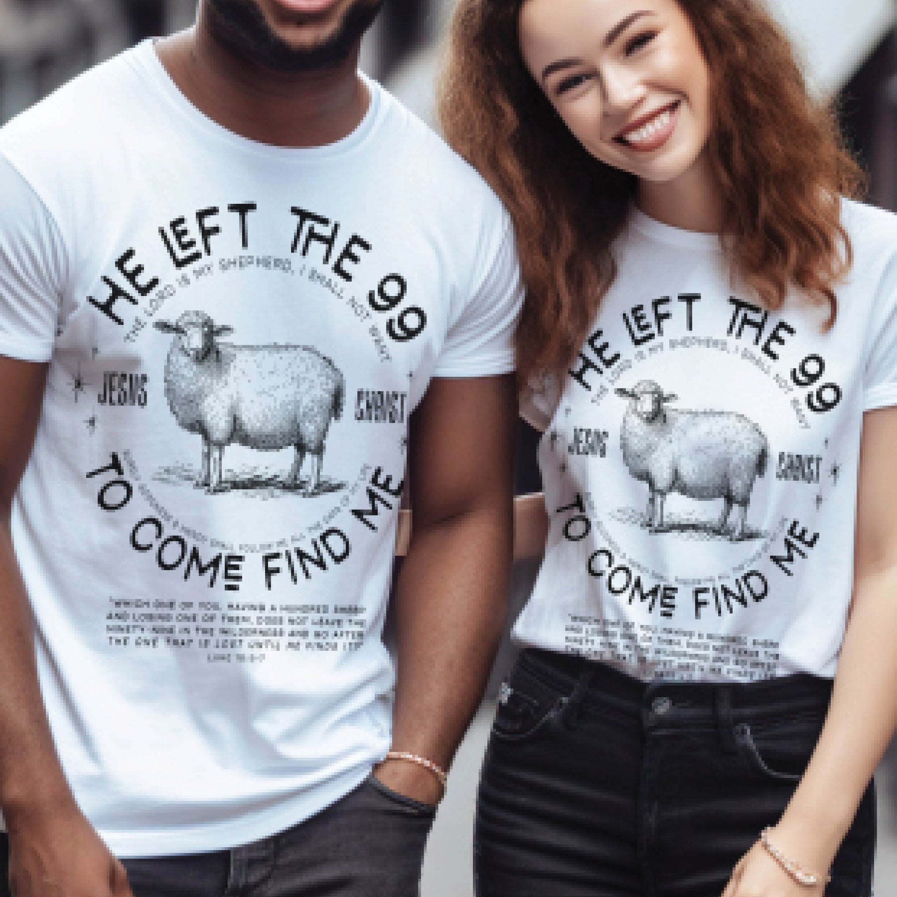 A black man and woman wearing white Christian unisex t-shirts with He Left the 99 to Come Find Me Jesus Christ Luke 15 bible verse saying and vintage sheep illustration graphic and distressed text printed in black