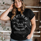 Woman wearing a black t-shirt with a religious Luke 15 sheep and Jesus Christ design and text.