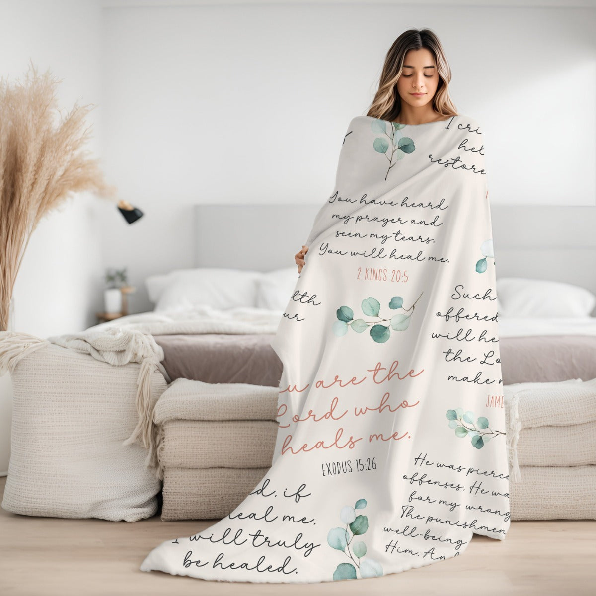 Young woman wrapped up in a cozy silky soft luxurious ivory, dusty rose, green and white minky blanket with 8 Christian healing scripture bible verses to heal and protect with sage green watercolor eucalyptus branches