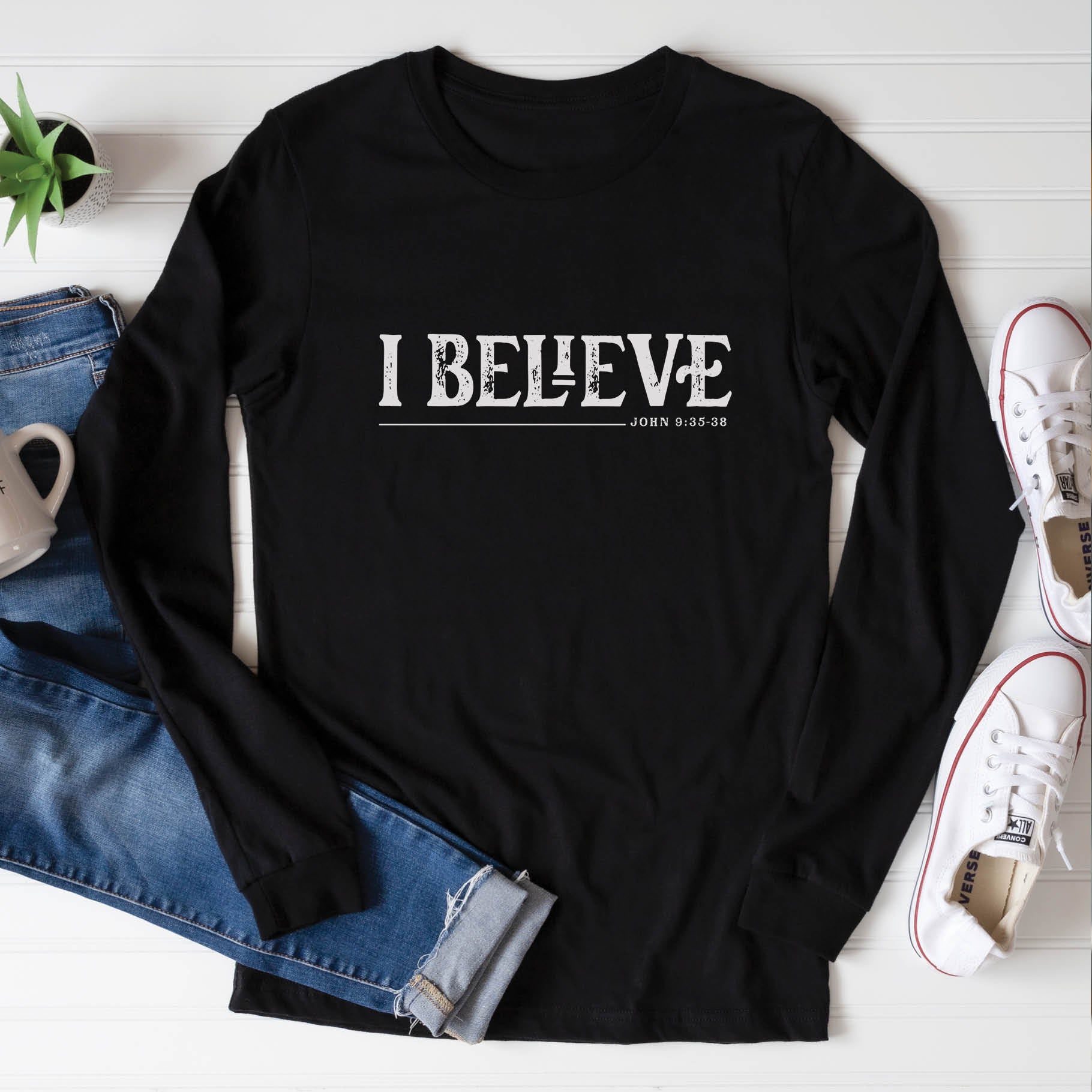 Black unisex long sleeve Christian t-shirt featuring distressed 'I Believe - John 9:35-38' Bible verse print, perfect for men and women expressing their faith