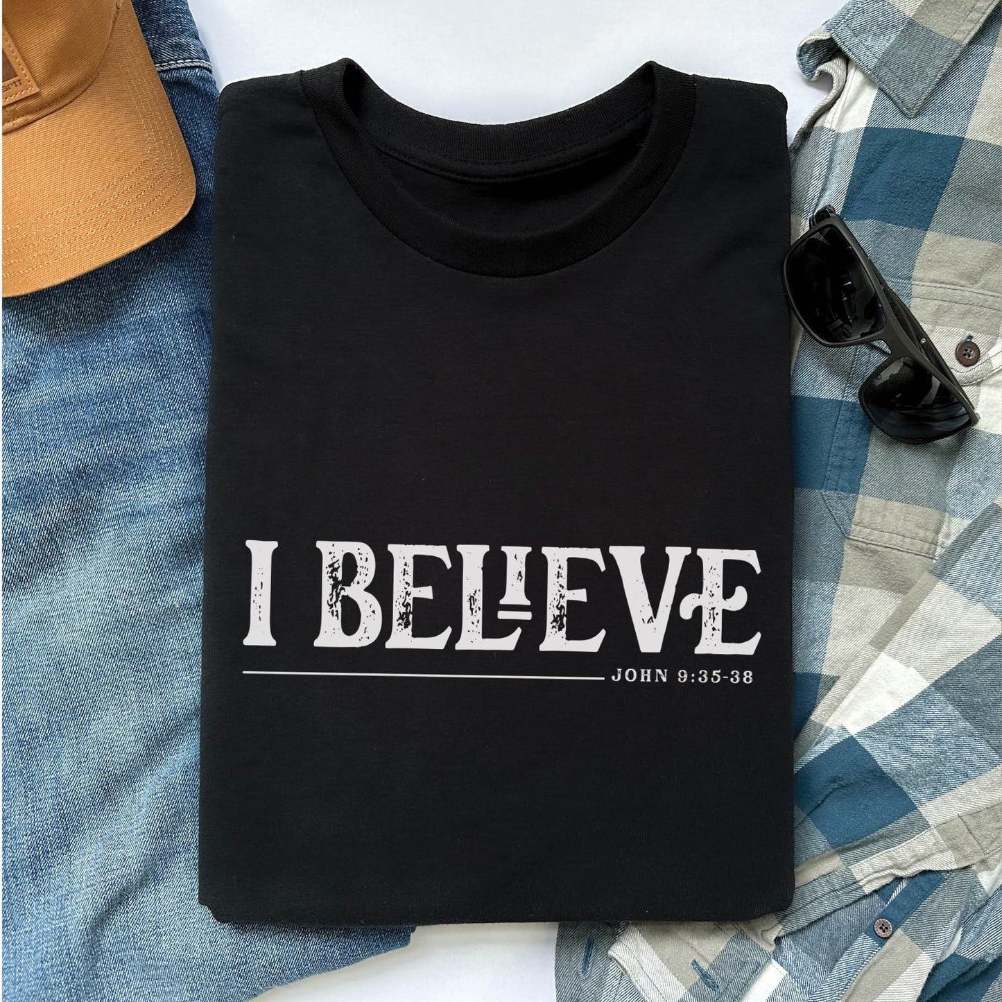 Soft black unisex Christian t-shirt featuring distressed 'I Believe - John 9:35-38' Bible verse print in white, perfect for men and women expressing their faith