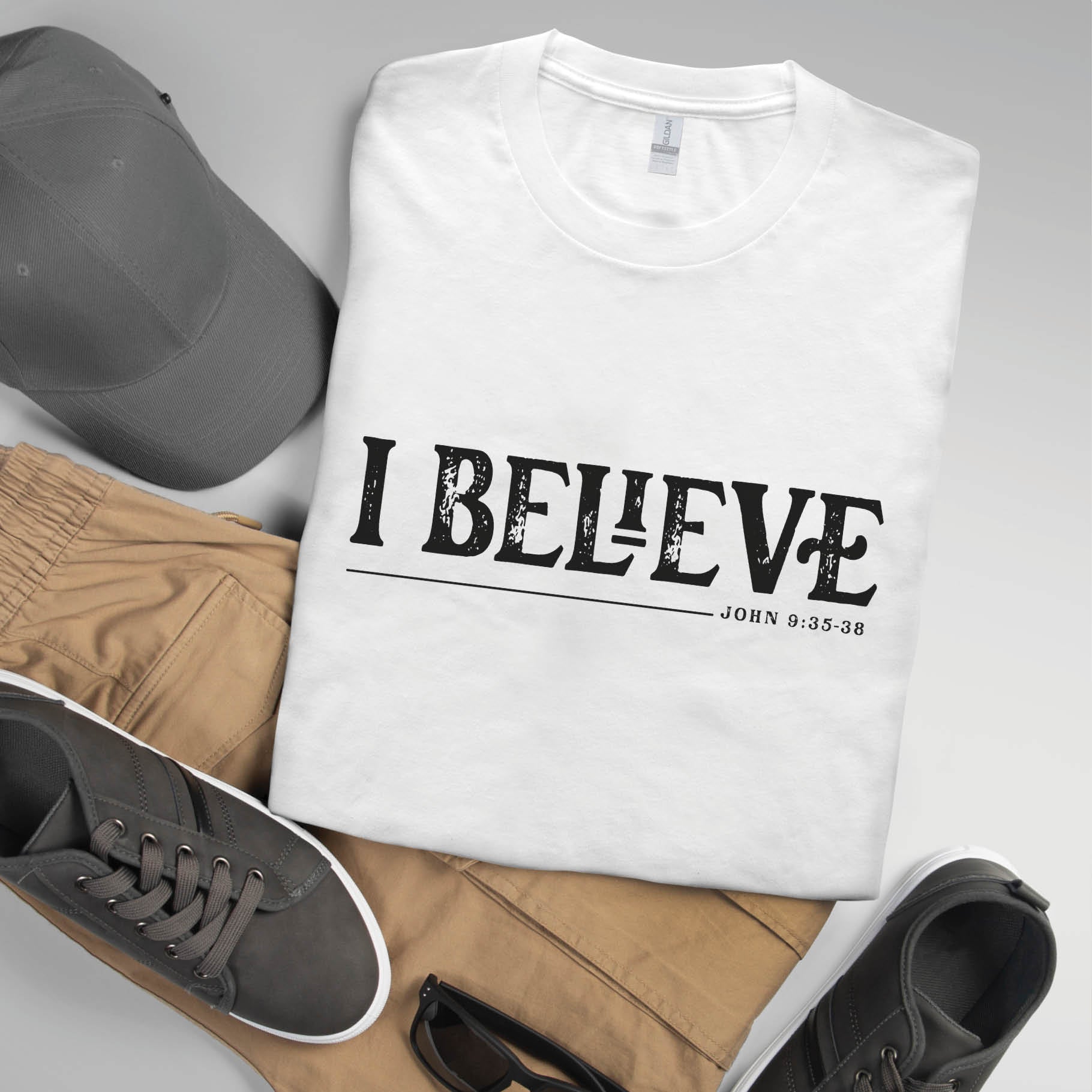 Soft white unisex Christian t-shirt featuring distressed 'I Believe - John 9:35-38' Bible verse print in white, perfect gift for men and women expressing their faith, and great men's or women's group conference shirt