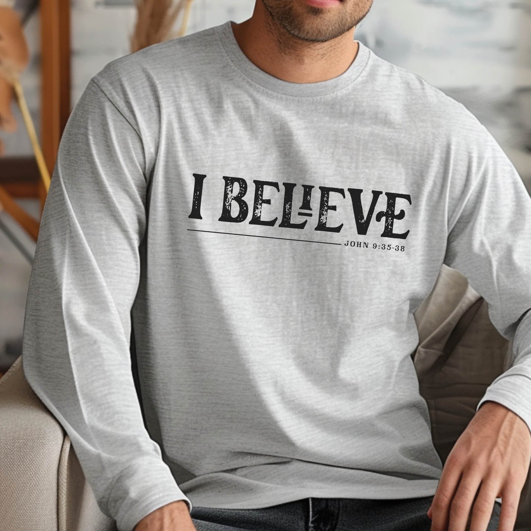 Sport gray unisex long sleeve unisex Christian t-shirt featuring distressed 'I Believe - John 9:35-38' Bible verse print, perfect for men and women expressing their faith