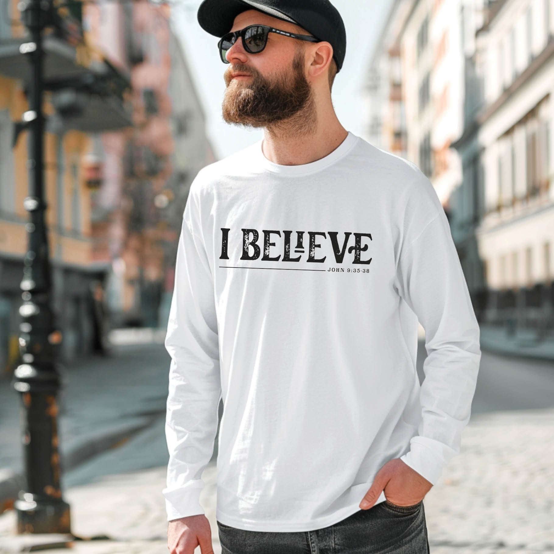 White unisex long sleeve unisex Christian t-shirt featuring distressed 'I Believe - John 9:35-38' Bible verse print, designed for men and women expressing their faith