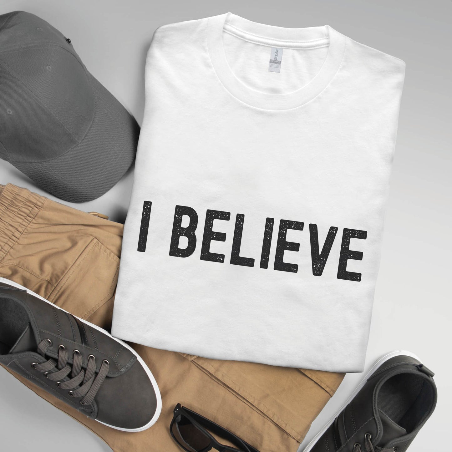 I BELIEVE Christian aesthetic faith-based bold statement distressed typography t-shirt design printed in matte black on white unisex fit t-shirt, designed for men & women believers