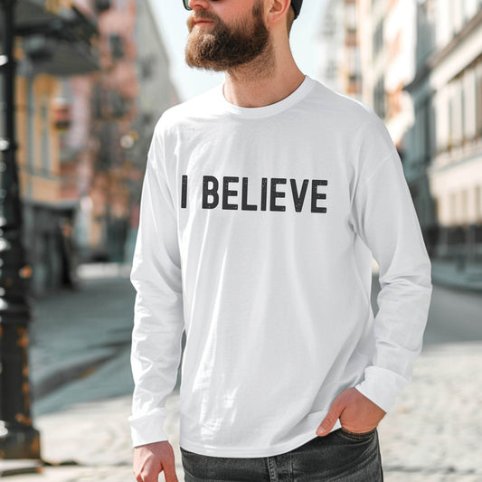 White cozy long sleeve t-shirt with a bold faith-based statement "I BELIEVE" distressed typography design printed in black, created for Christian men and women Jesus believers