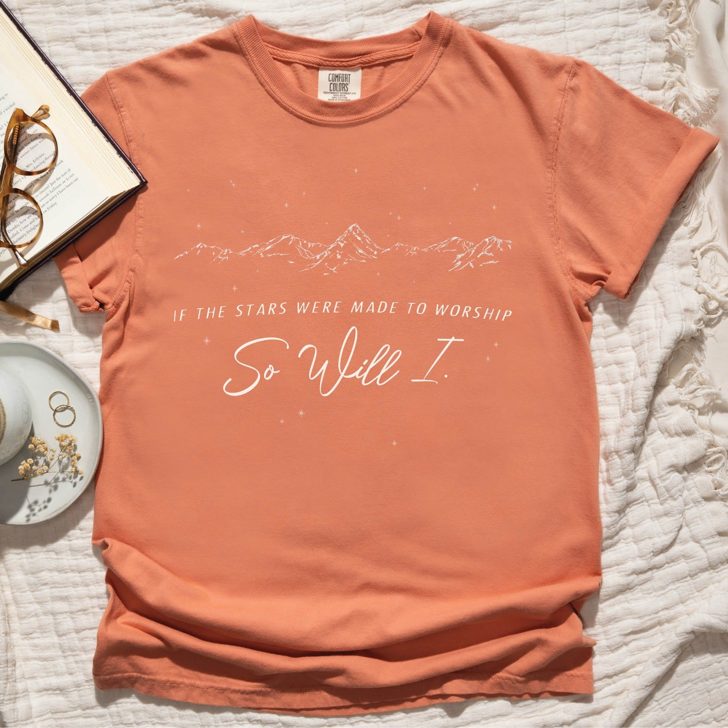Terracotta color Christian unisex Comfort Colors 1717 t-shirt with a white hand-drawn mountain range and starry sky that says this faith-based bible verse quote, "If the Stars Were Made to Worship So Will I", created for men and women Kingdom of God believers