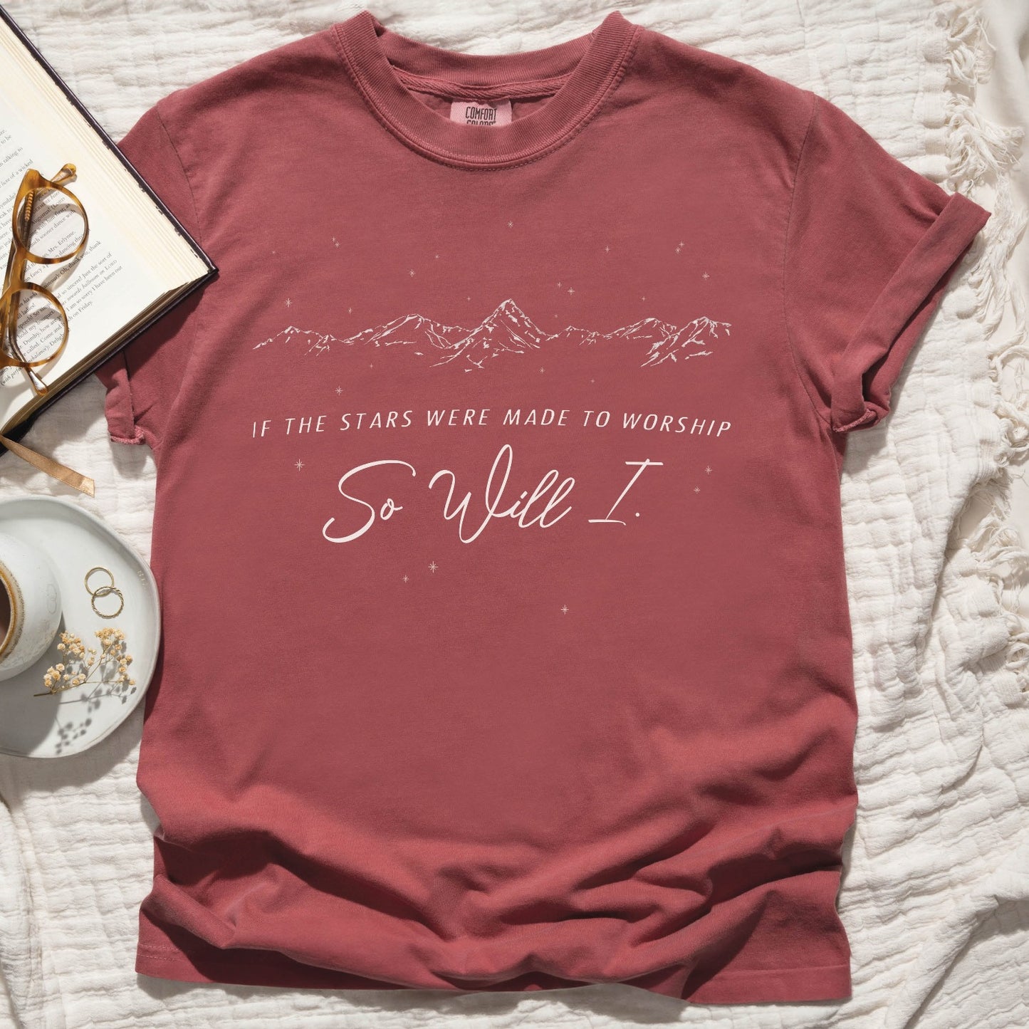Crimson dusty mauve color garment-dyed unisex Comfort Colors 1717 t-shirt with a white hand-drawn mountain range and starry sky that says this faith-based bible verse quote, "If the Stars Were Made to Worship So Will I", created for Christian men and women Kingdom believers