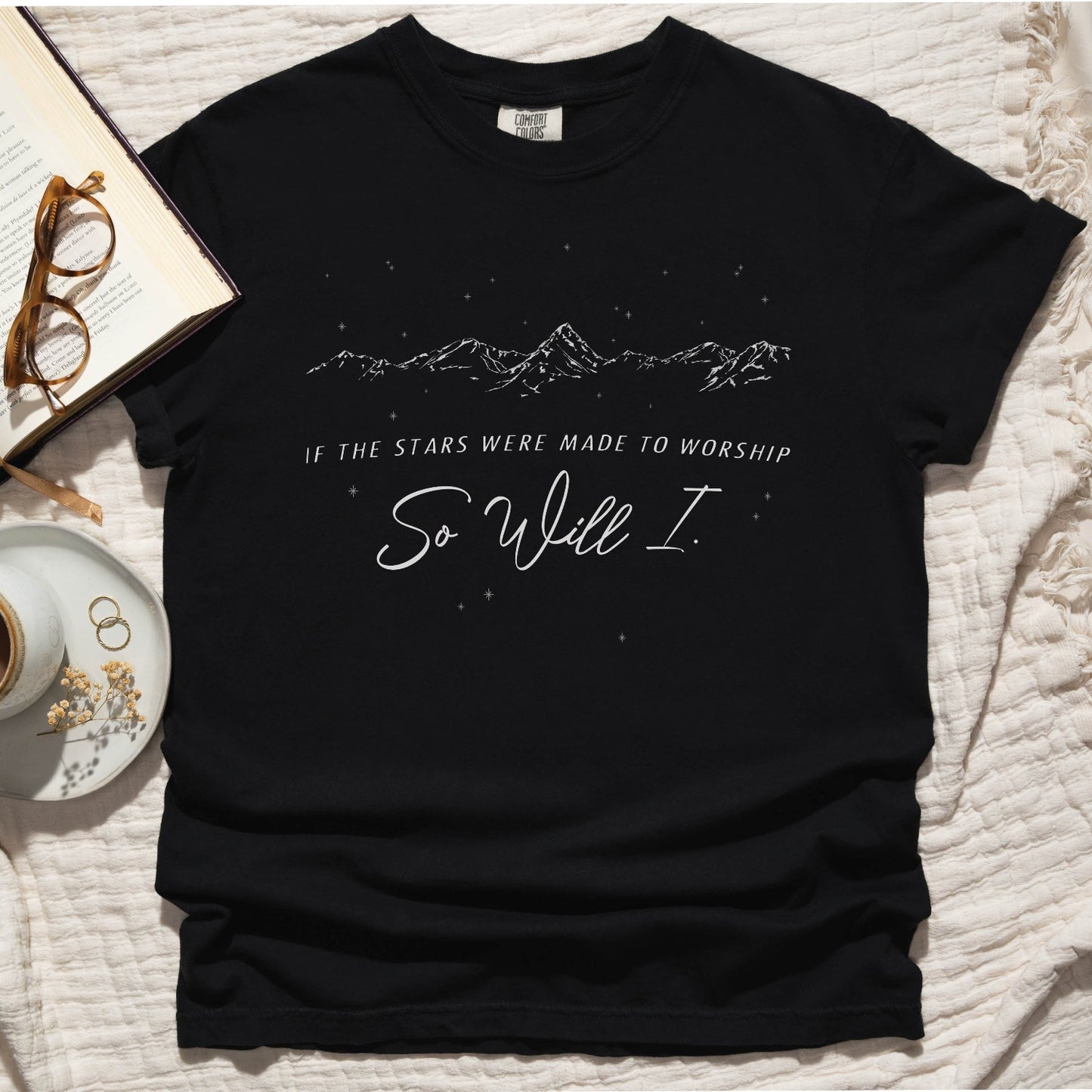 Black color garment-dyed unisex Comfort Colors 1717 t-shirt with white hand-drawn mountain range and starry sky that says this faith-based bible verse quote, "If the Stars Were Made to Worship So Will I", created for Christian men and women Kingdom believers