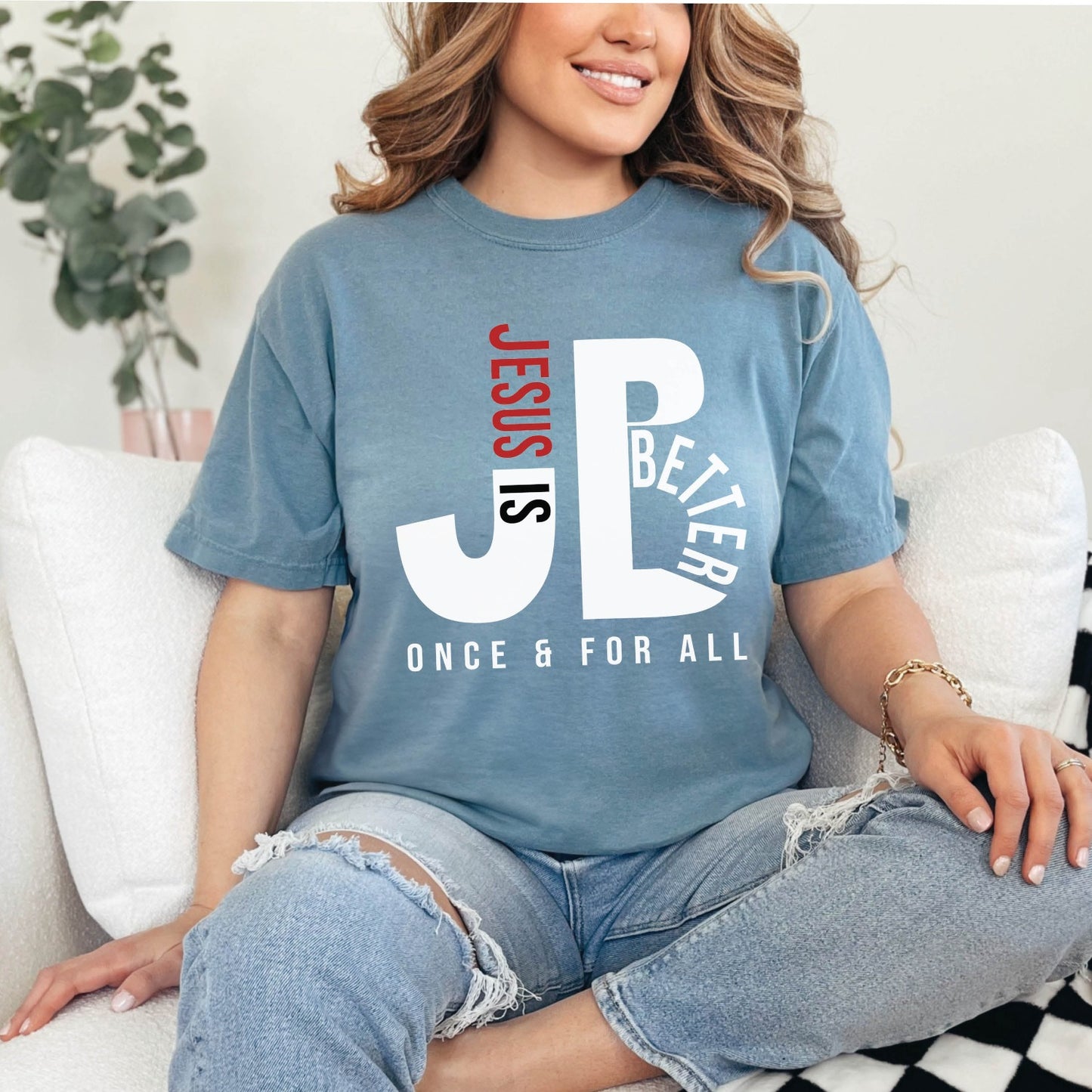 Trendy woman wearing an Ice Blue color JB typography Jesus is Better Once and For All Christian book of Hebrews Unisex Comfort Colors C1717 t-shirt, created for faith-based women and men