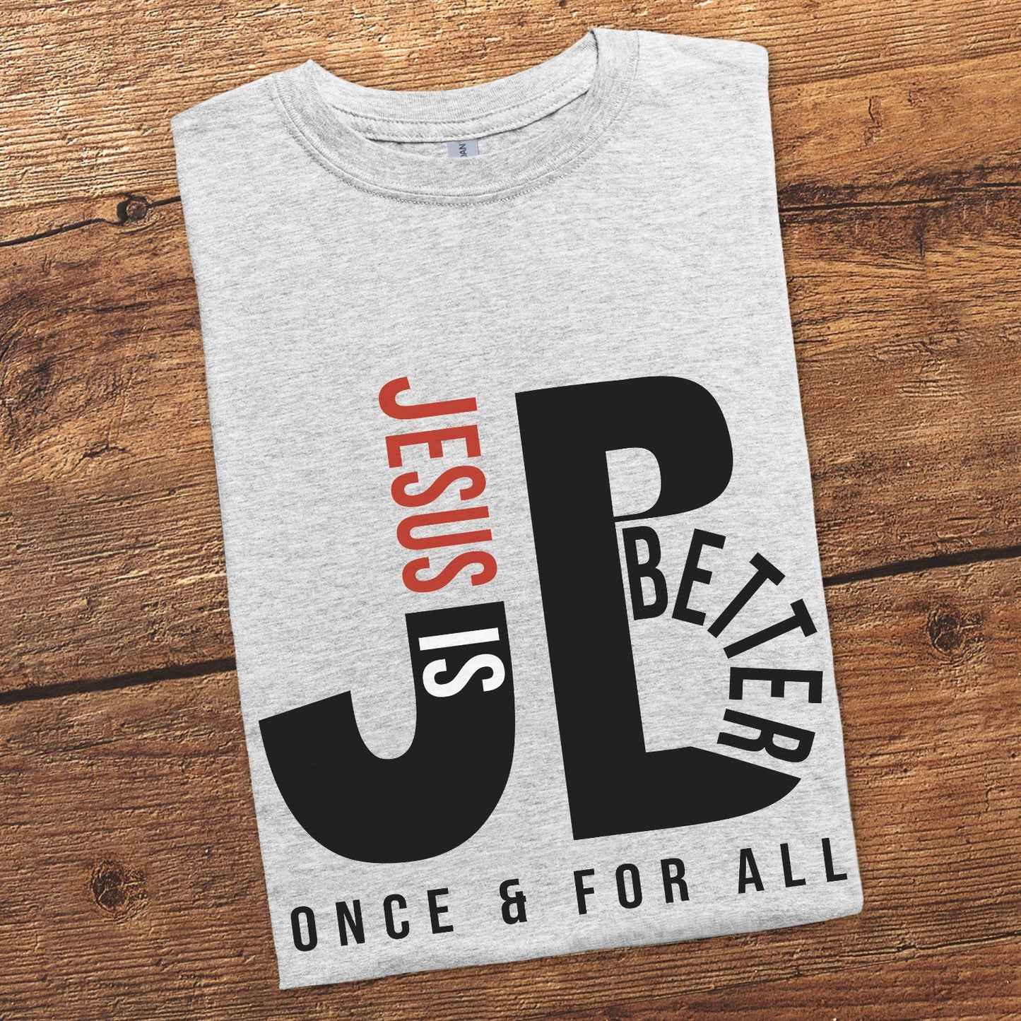 "JB" typography "Jesus is Better Once and For All" design in black and red letters, based on the Christian bible book of Hebrews, printed on a heather sport gray color Unisex t-shirt, created for faith-based men and women