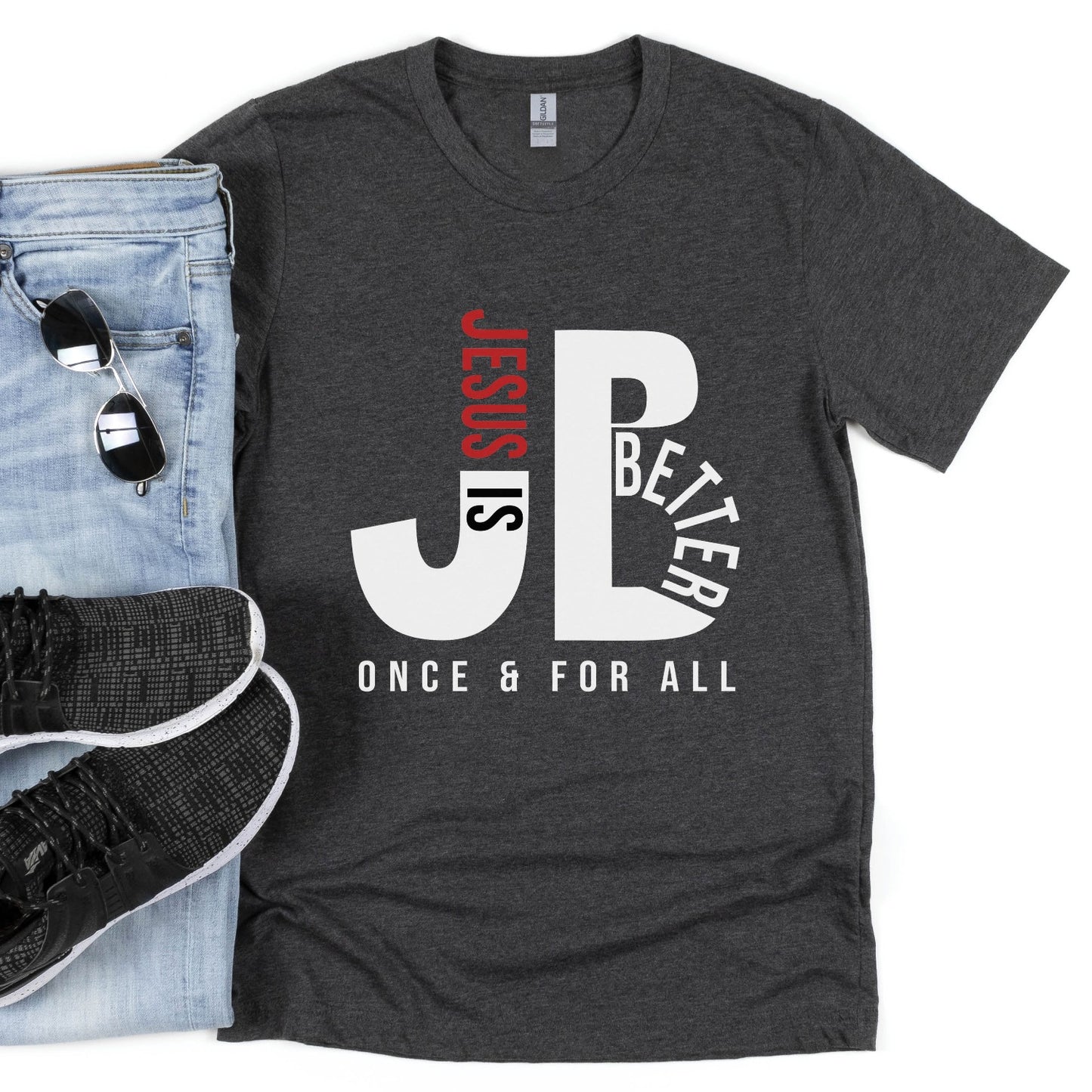 Men's "JB" typography "Jesus is Better Once and For All" design in white and red letters, based on the Christian bible book of Hebrews, printed on a heather dark gray color Unisex t-shirt, created for faith-based men and women, great father's day dad gift for him