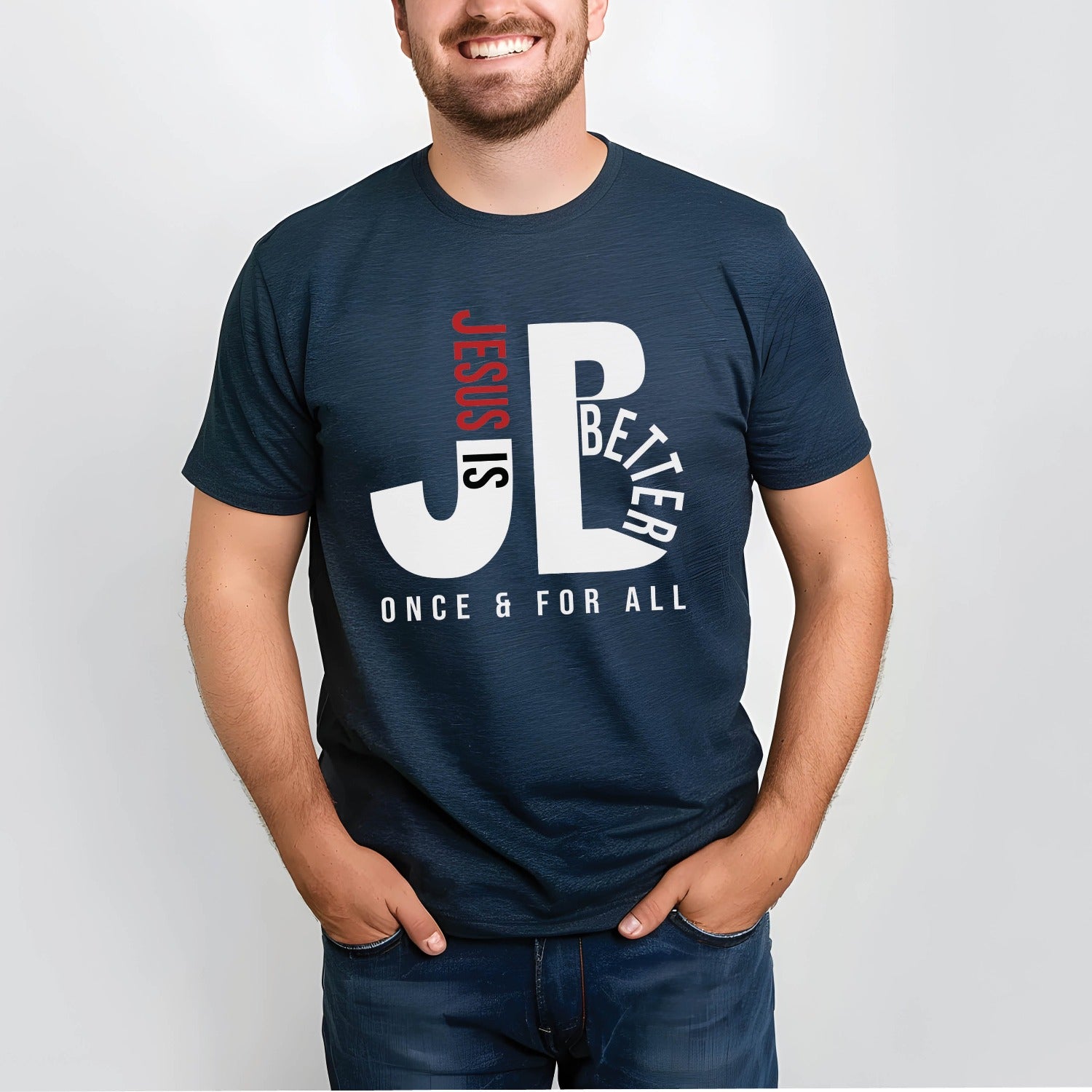Man like a Dad wearing a "JB" typography "Jesus is Better Once and For All" design in white and red letters, based on the Christian bible book of Hebrews, printed on a navy blue color Unisex t-shirt, created for faith-based men and women, great gift for father's day