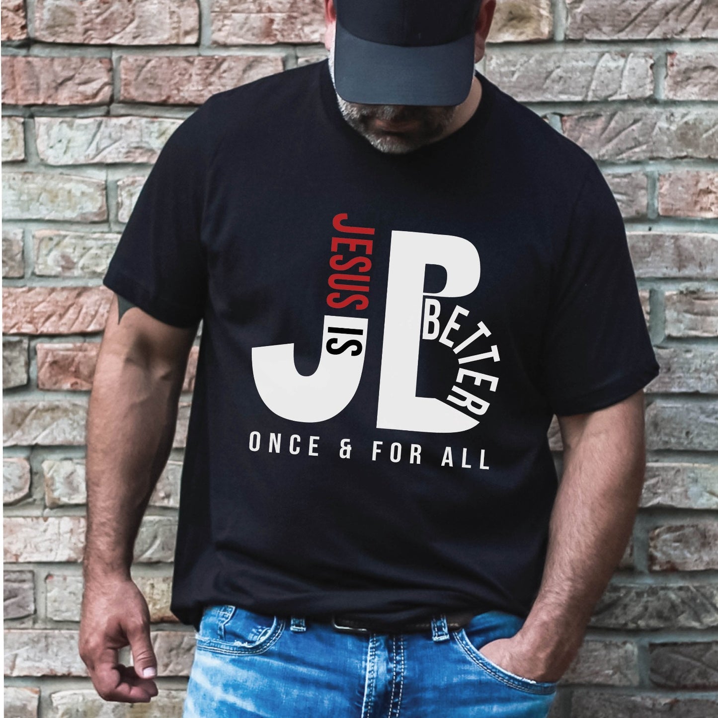 Man like a Dad wearing a "JB" typography "Jesus is Better Once and For All" design in white and red letters, based on the Christian bible book of Hebrews, printed on a black color Unisex t-shirt, created for faith-based men and women, great father's day gift for him