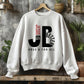 Cozy "JB" typography "Jesus is Better Once and For All" design in black and red letters, based on the Christian bible book of Hebrews, printed on a white color Unisex crewneck sweatshirt, created for faith-based men and women, great father's day gift for Dad