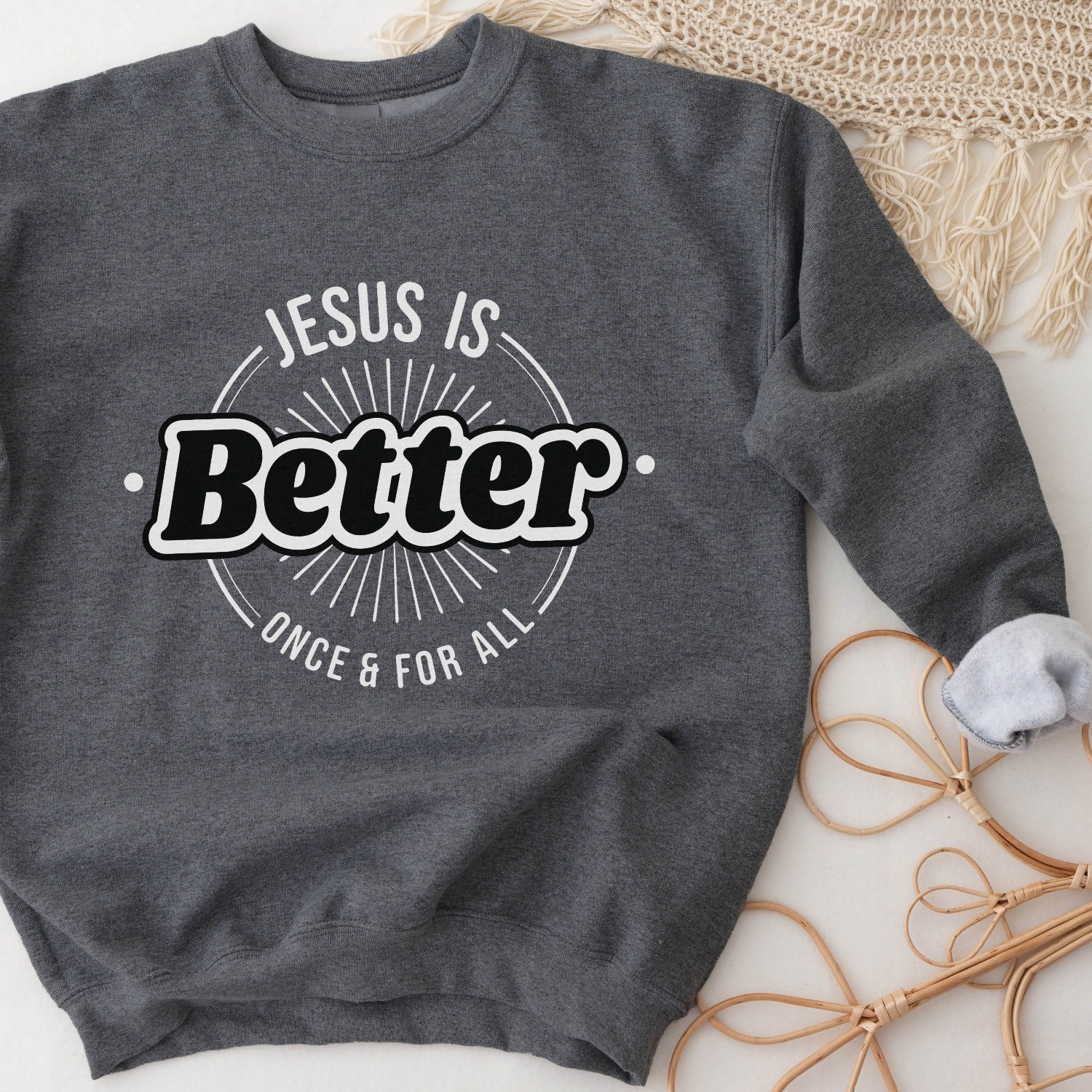 Heather dark gray faith-based cozy sweatshirt with "Jesus is BETTER - Once and For All" logo style design in white and black, created for Christian men and women