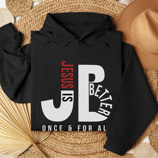 "JB" typography "Jesus is Better Once and For All" design in white and red letters, based on the Christian bible book of Hebrews, printed on a black color cozy unisex hoodie, created for faith-based men and women, great father's day gift for Dad
